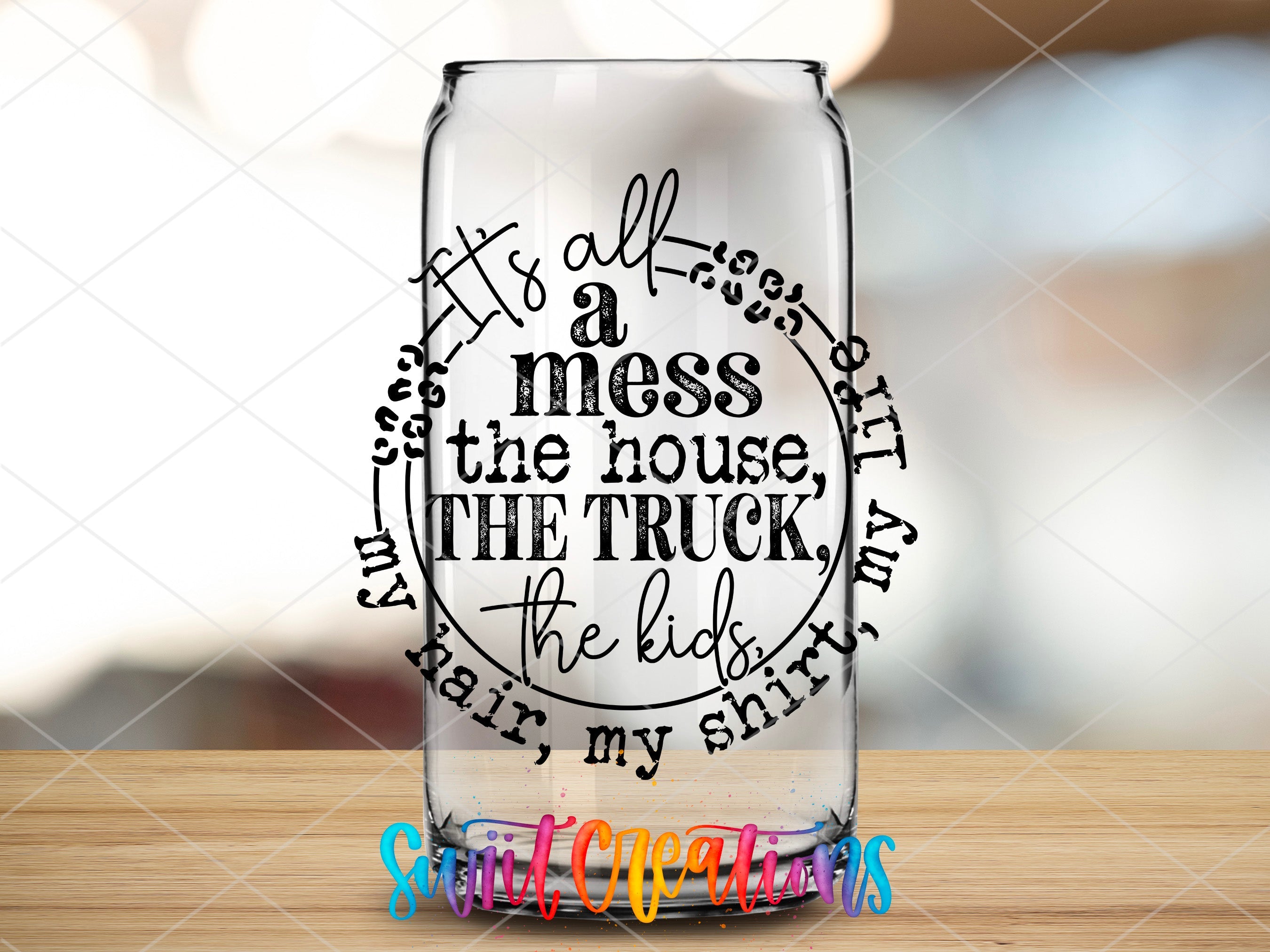 a glass with a quote on it sitting on a table