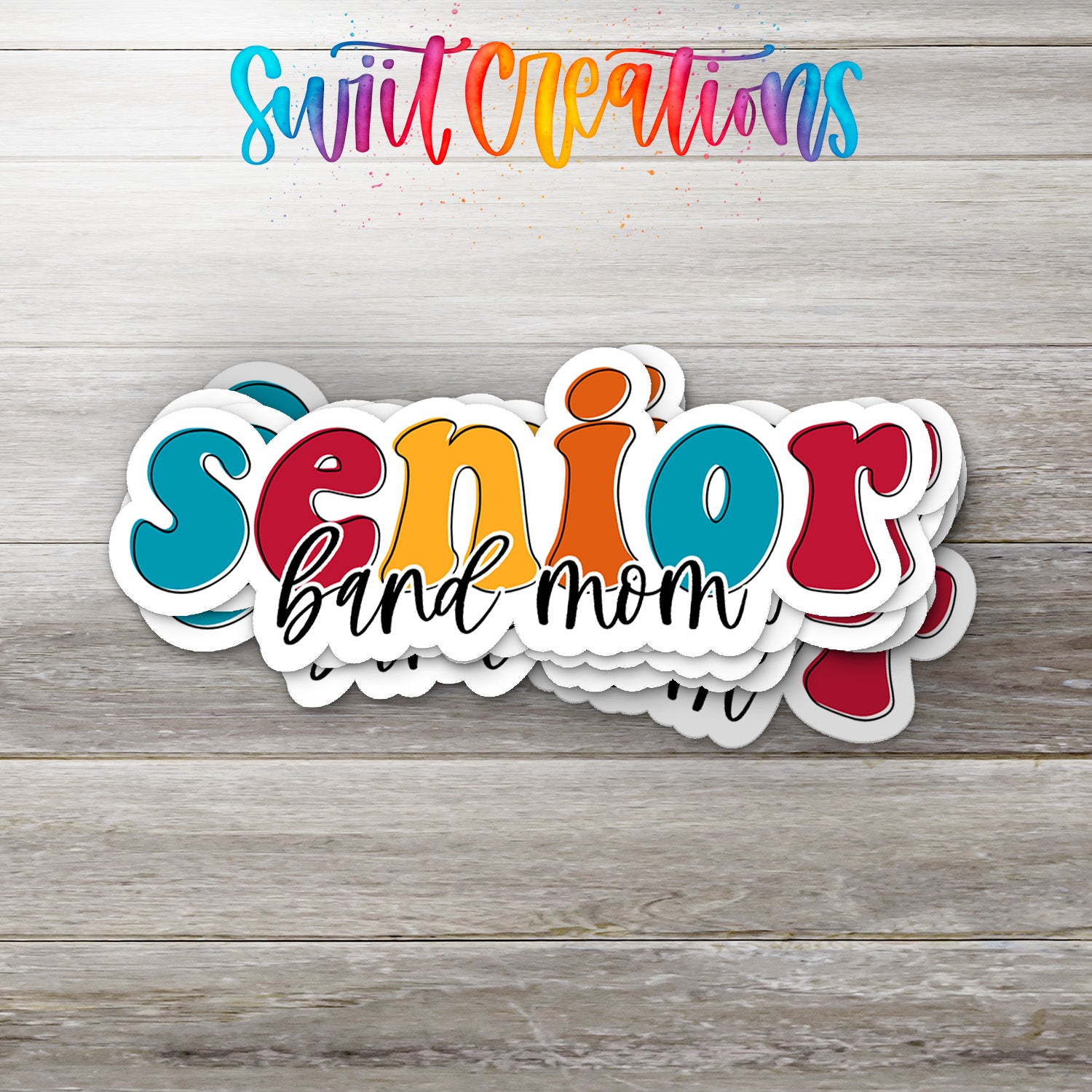 A colorful sticker design with the text "SENIOR band mom" written in a playful font, placed on a wooden surface.