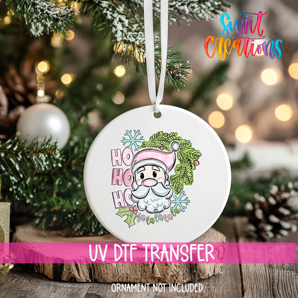 A white ornament with a Santa Claus face and the text "HOOK HOOK" hanging on a Christmas tree.