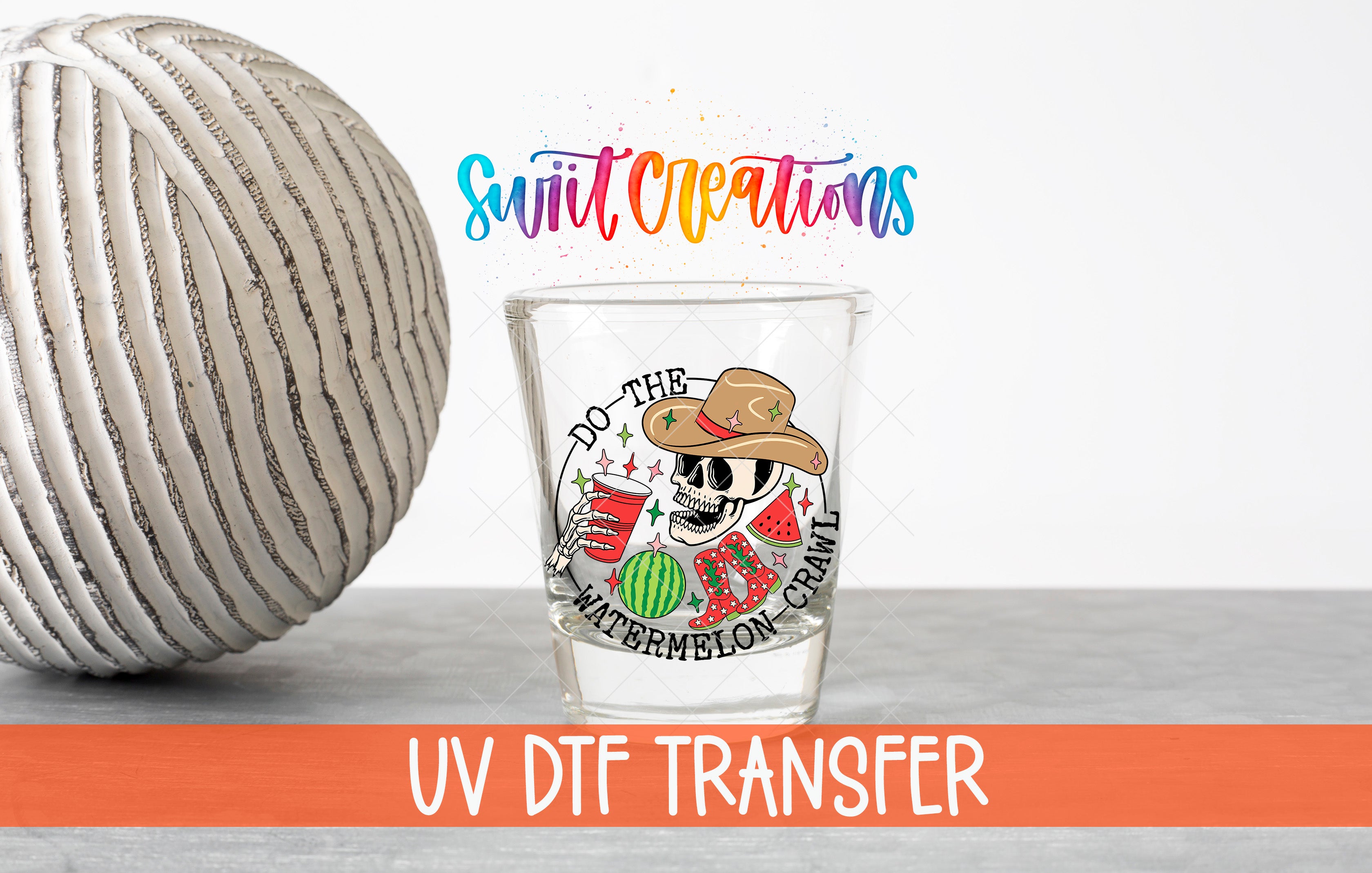 a glass with a colorful design and text, along with a large white ball and a rainbow-colored text overlay.