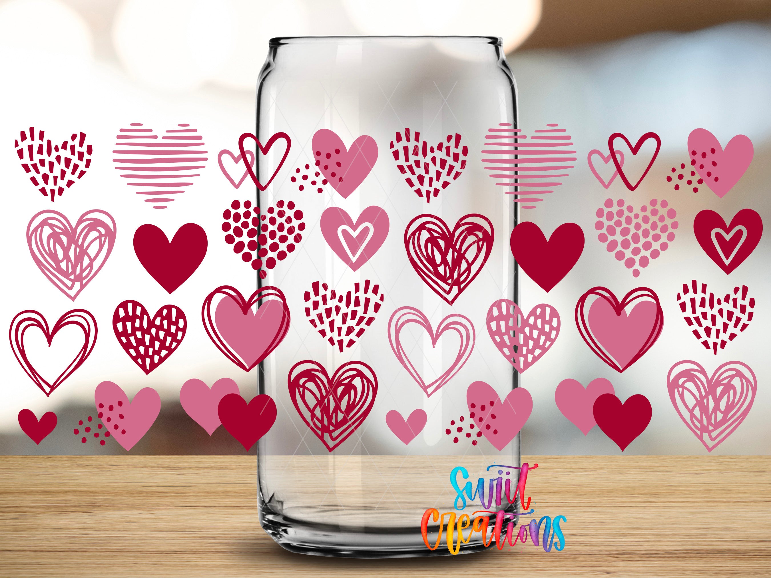 a clear glass jar with a pattern of hearts and hearts on its surface, set against a blurred background.