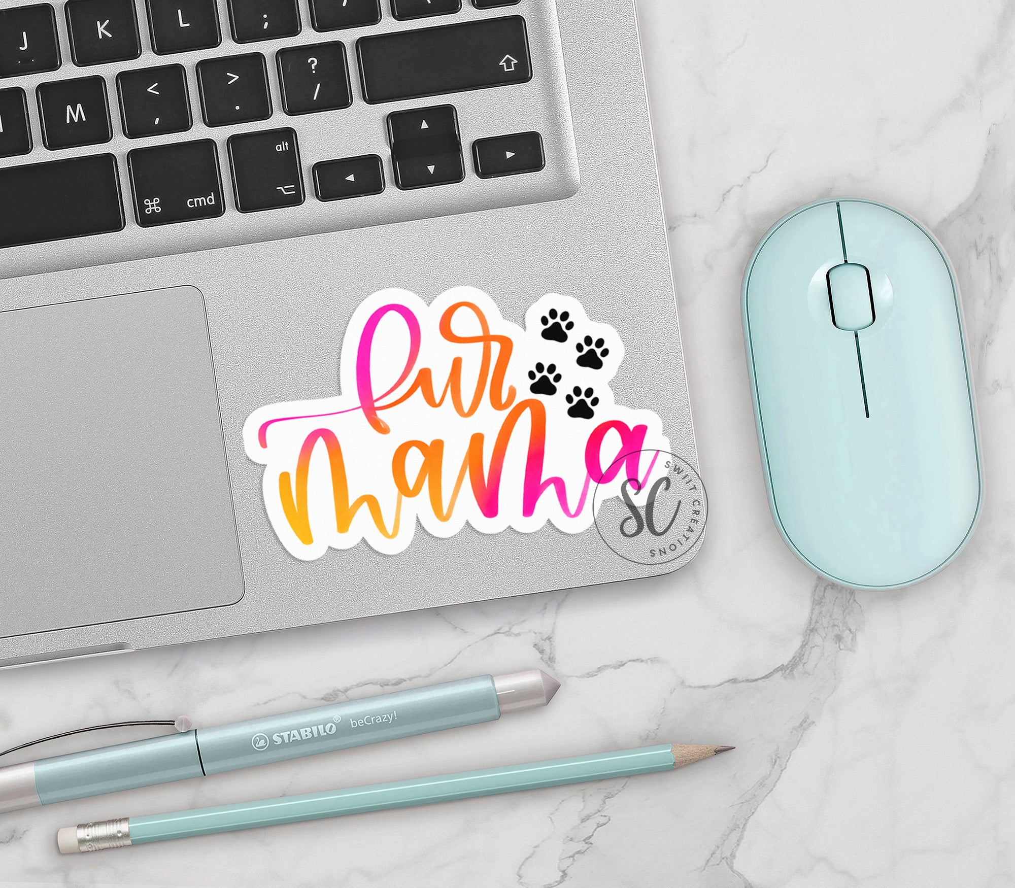 a laptop with a sticker that says air mama on it next to a mouse