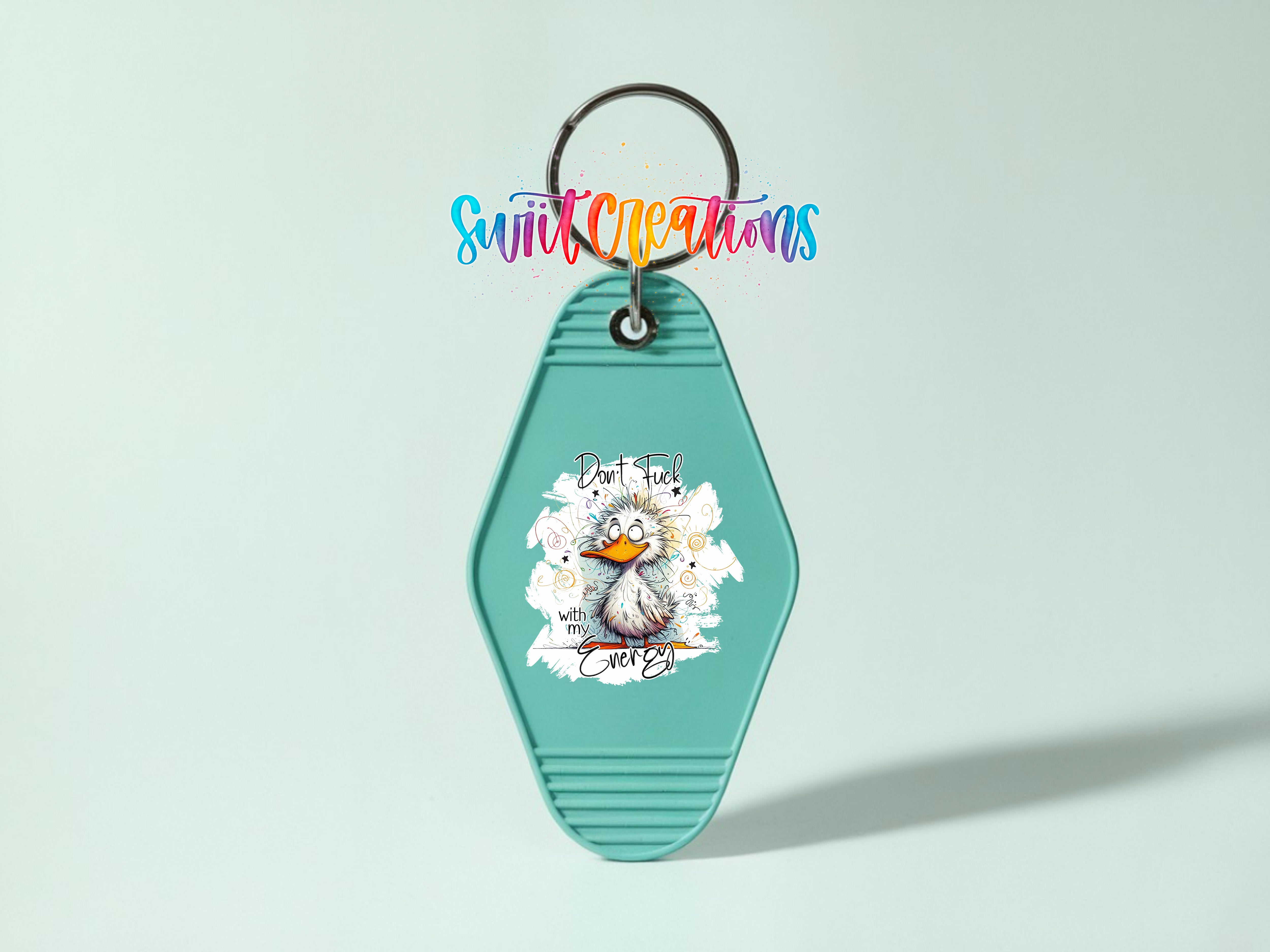 A turquoise keychain with a cartoon duck and the text "Don't mess with me" printed on it.