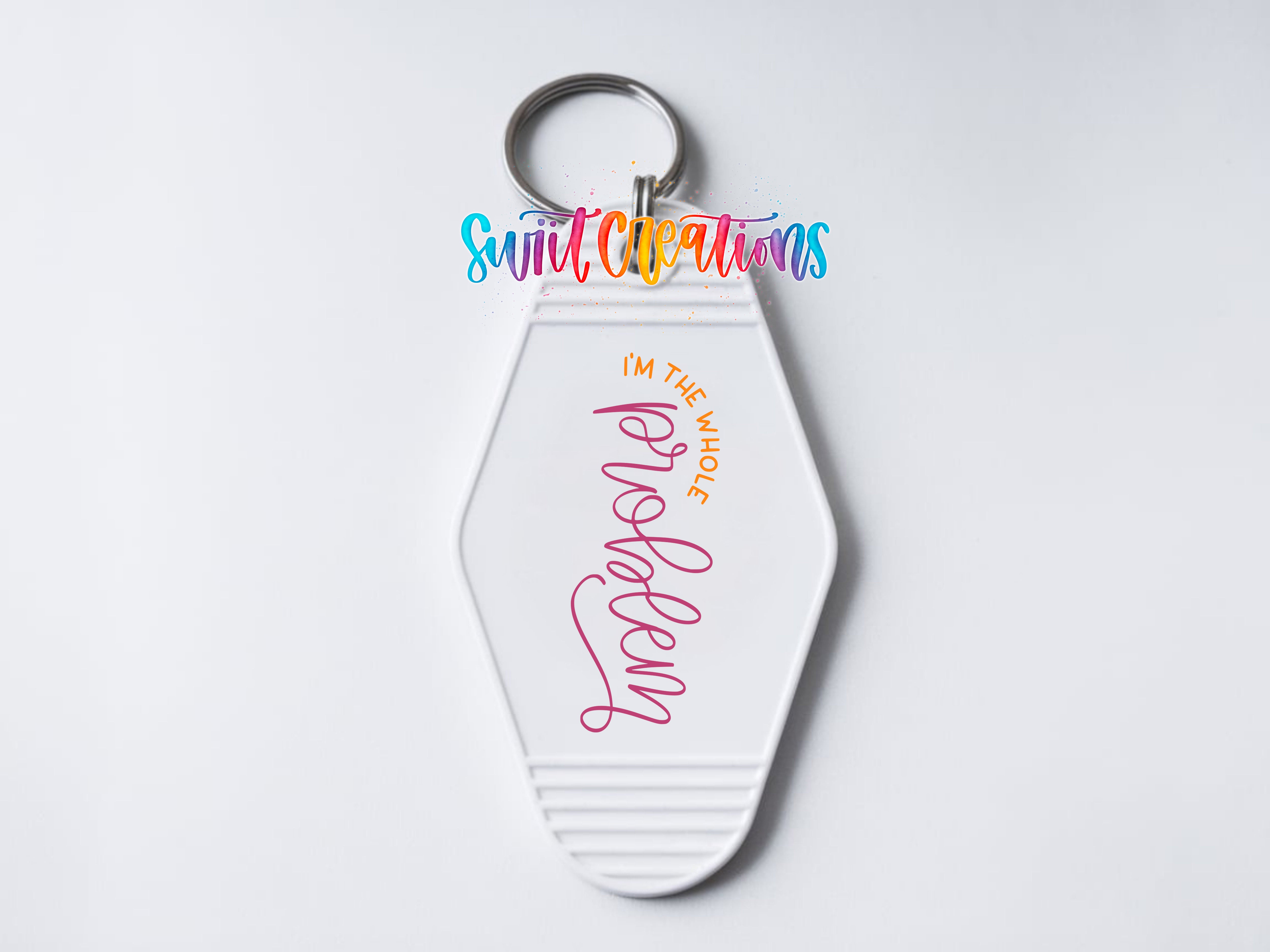 A white keychain with a colorful design and text on it.