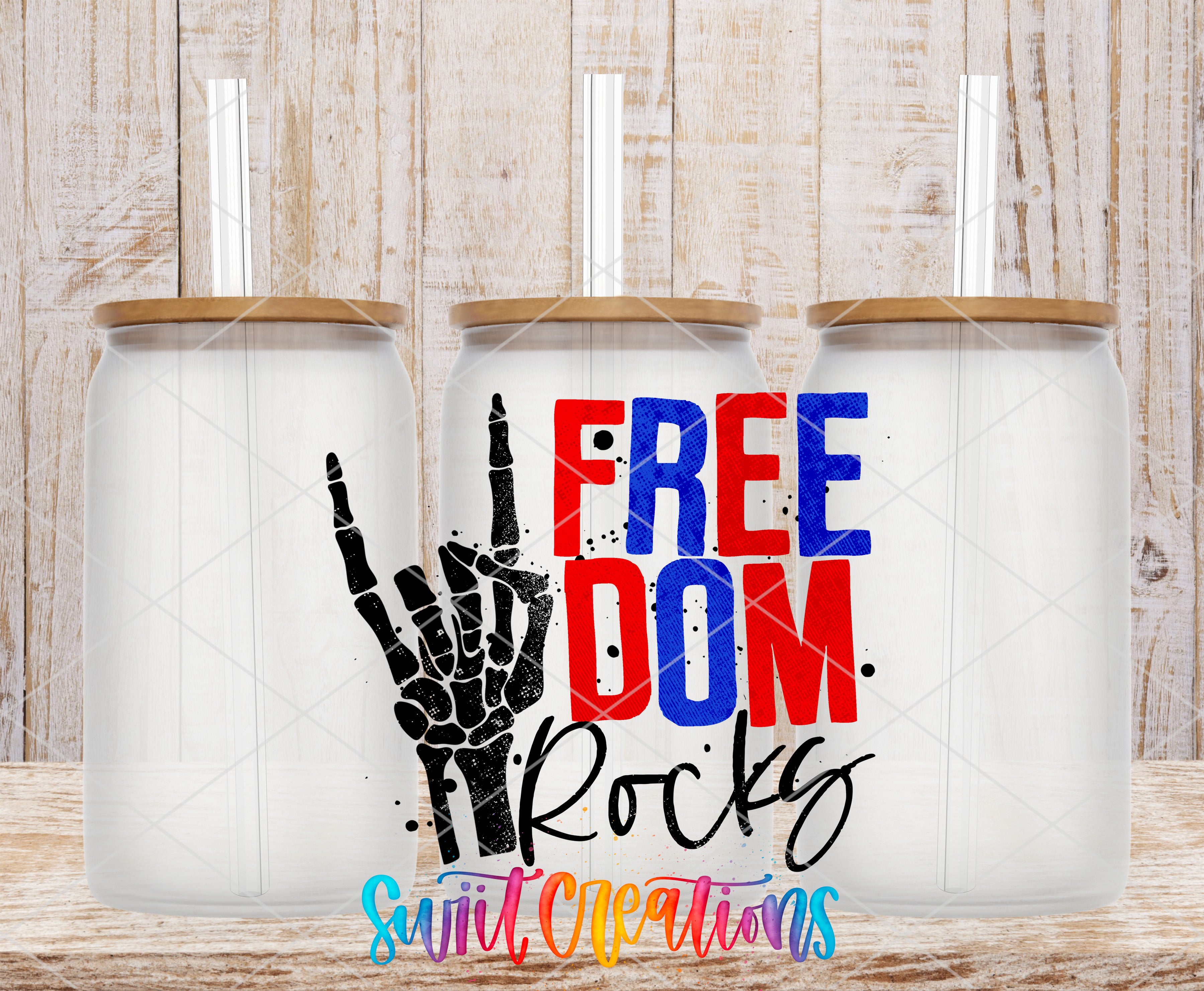 three glass jars with a bold, colorful design on them. The design includes the text "FREE" in red, "DOM" in blue, and "ROCKS" in black. The jars also have straws attached to the lids.