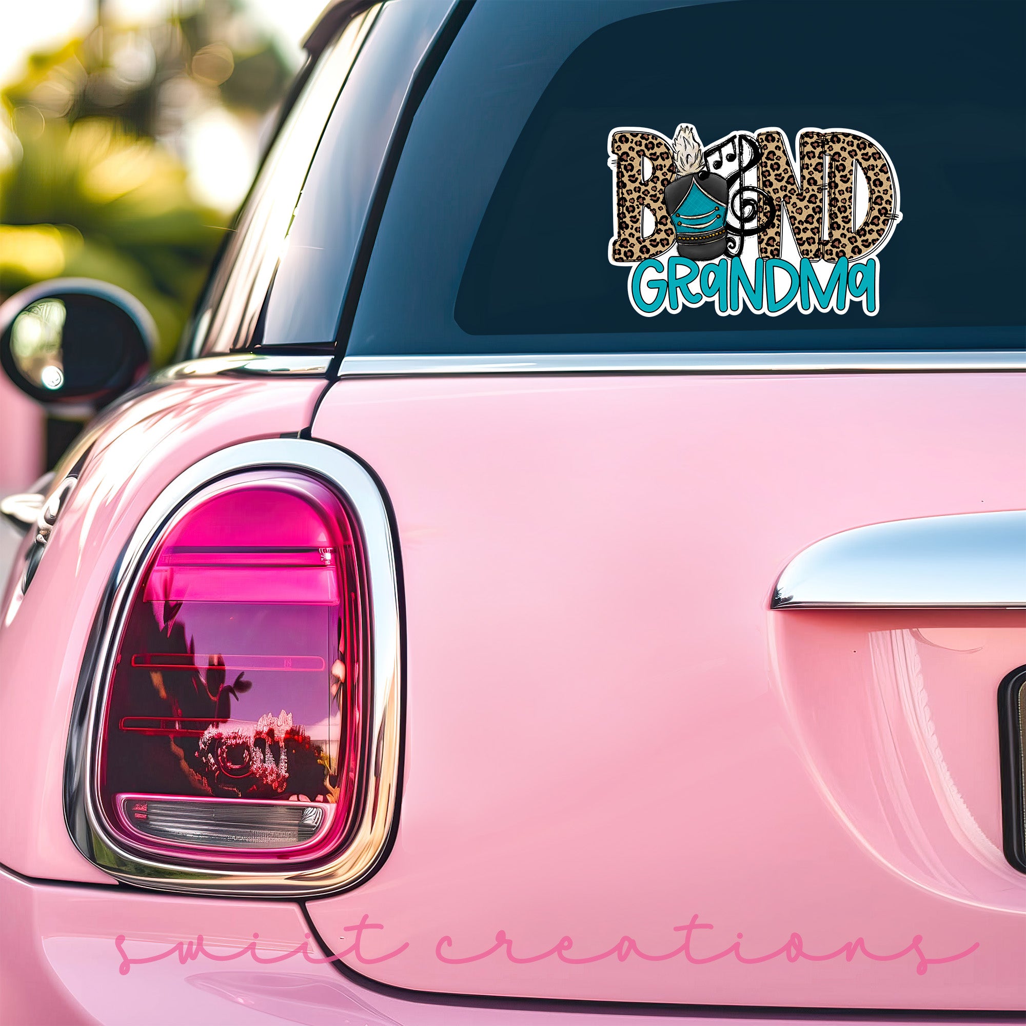 a pink car with a sticker on the back of it