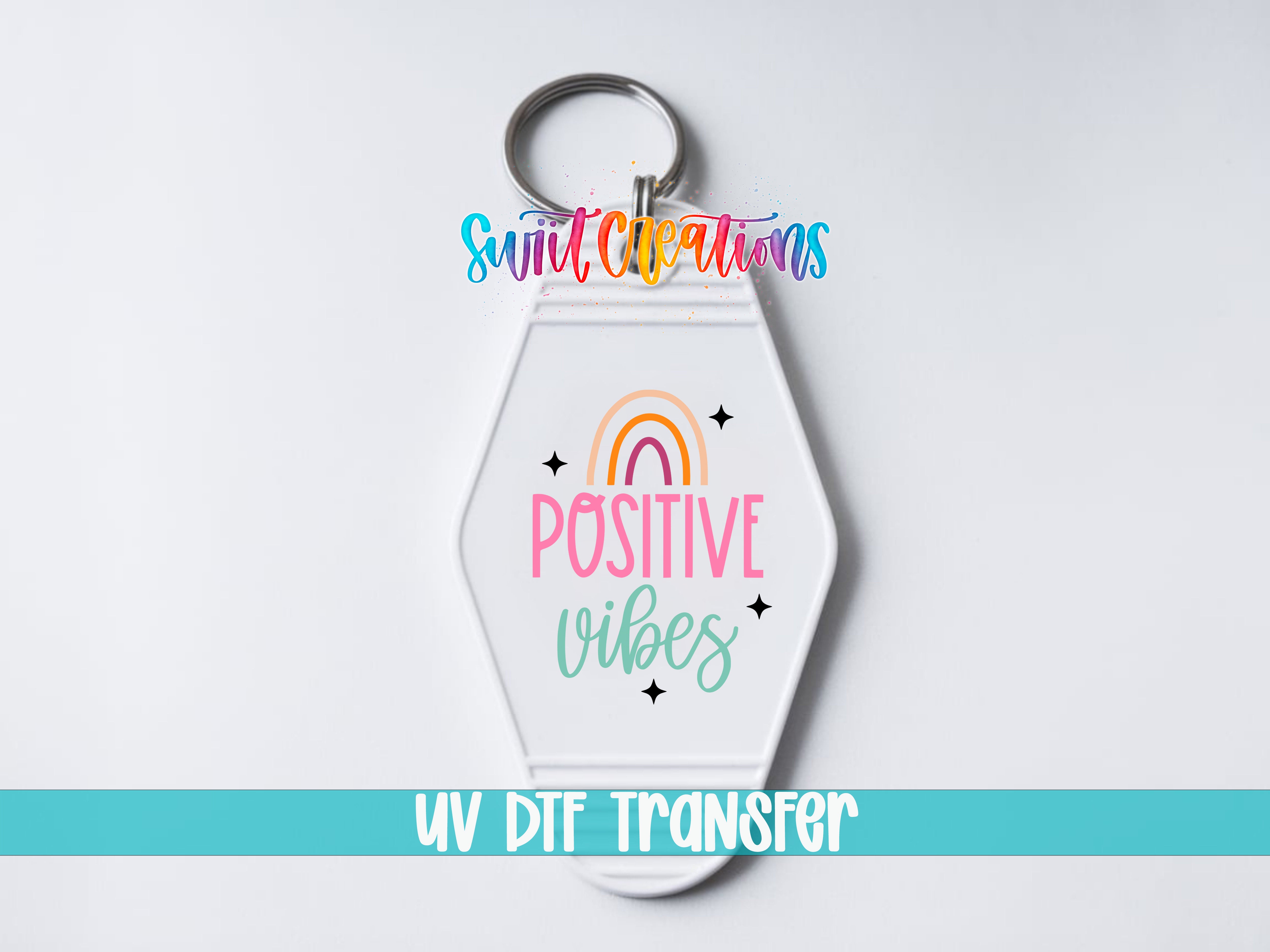 A keychain with a colorful design and text that says "POSITIVE VIBES" and "UV DIF TRANSFER".