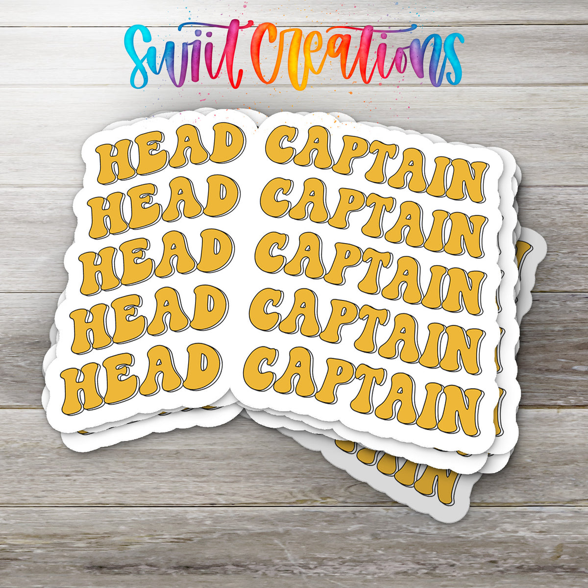 A stack of yellow stickers with the word "HEAD" written on them, placed on a wooden surface.