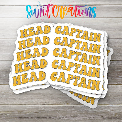 A stack of yellow stickers with the word "HEAD" written on them, placed on a wooden surface.