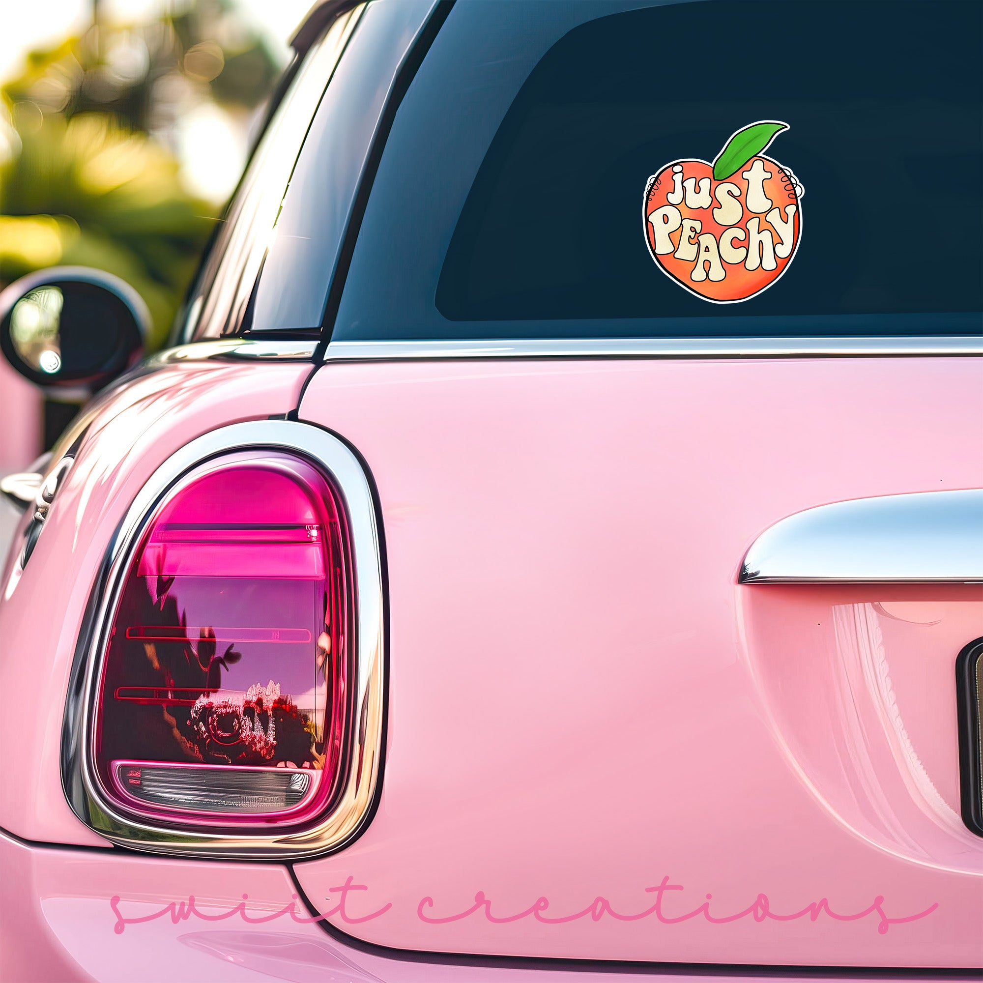 a pink car with a sticker that says just peachy