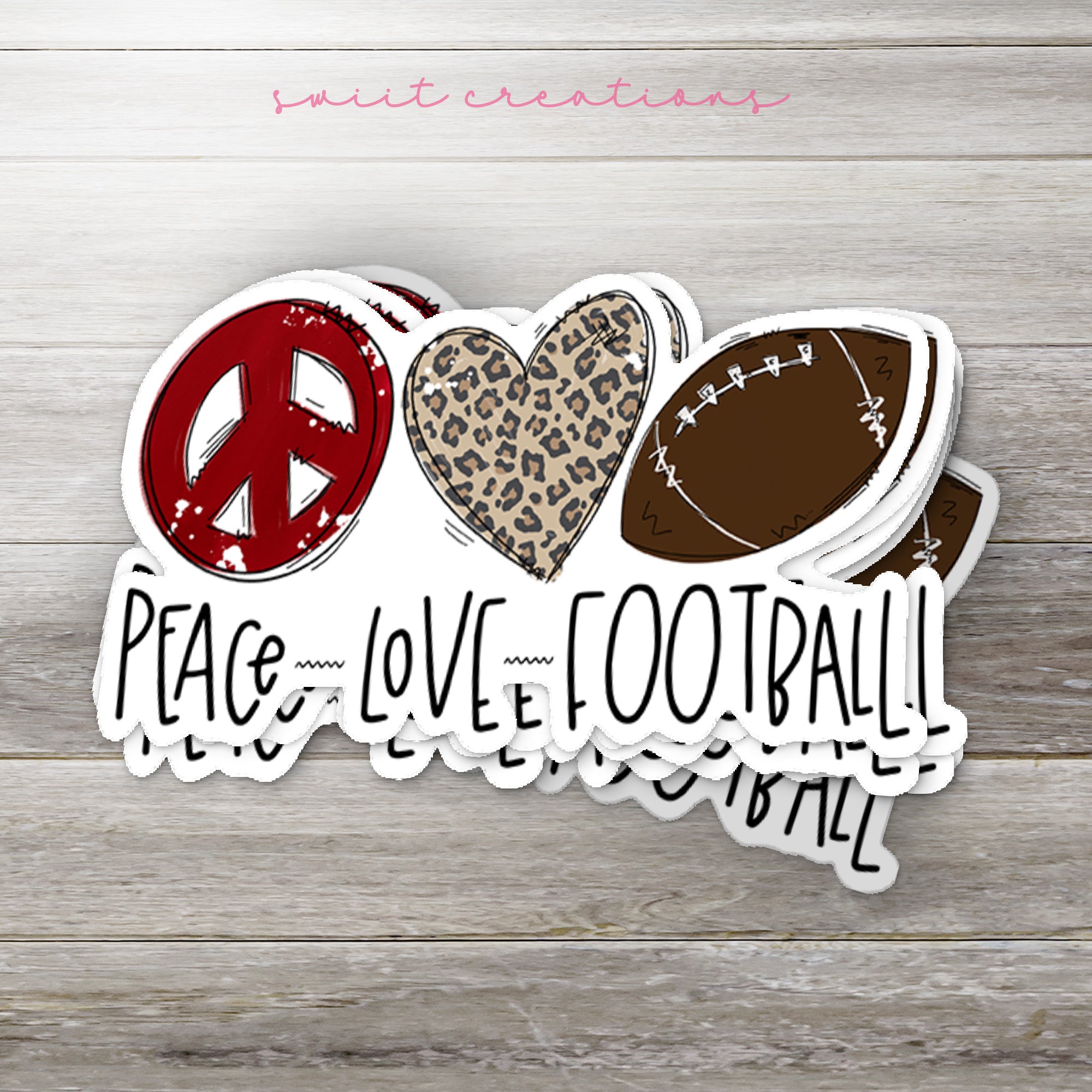 a peace love football sticker on a wooden surface