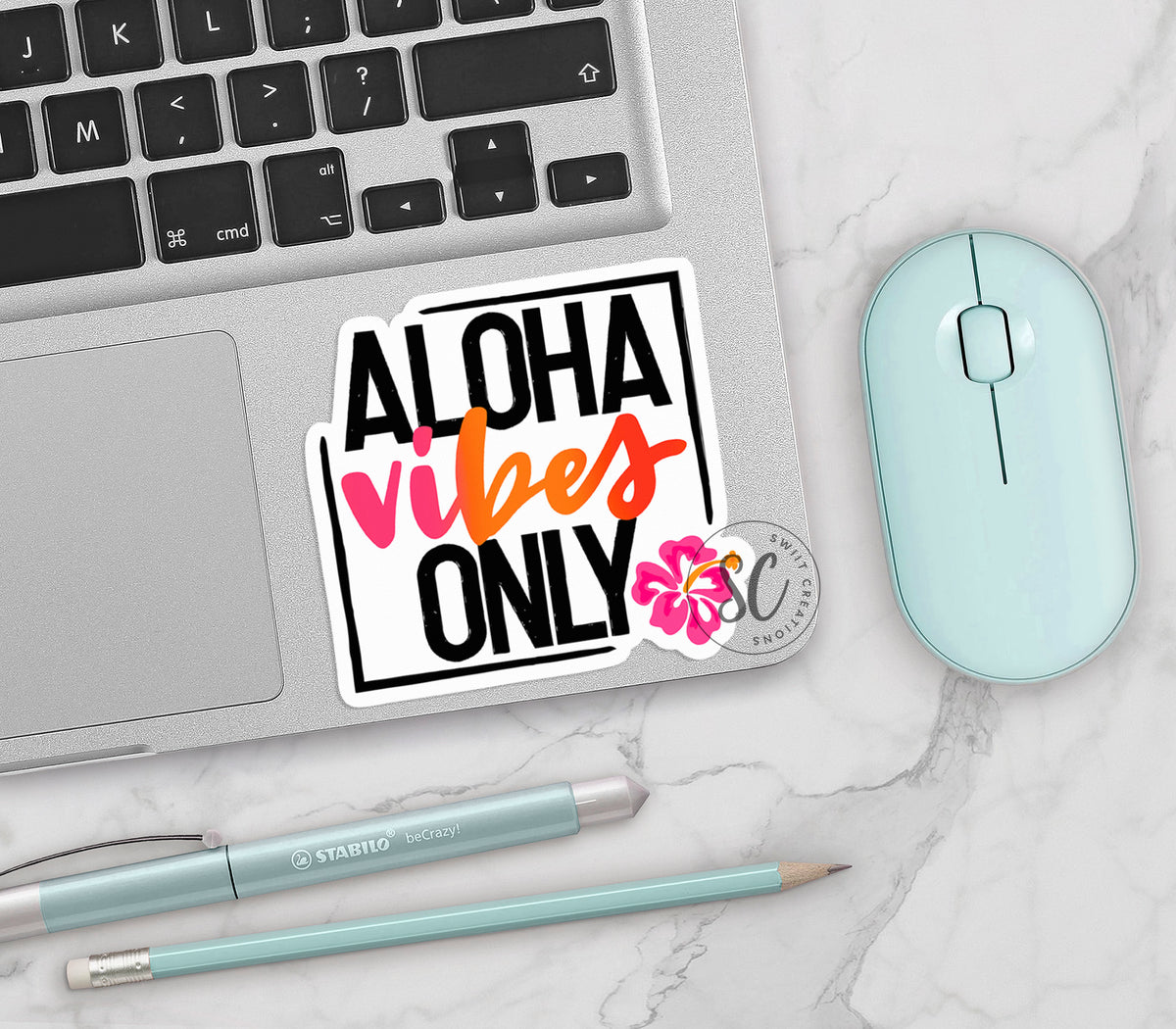 Aloha Vibes Only vinyl sticker on a silver laptop next to a mint mouse and pens