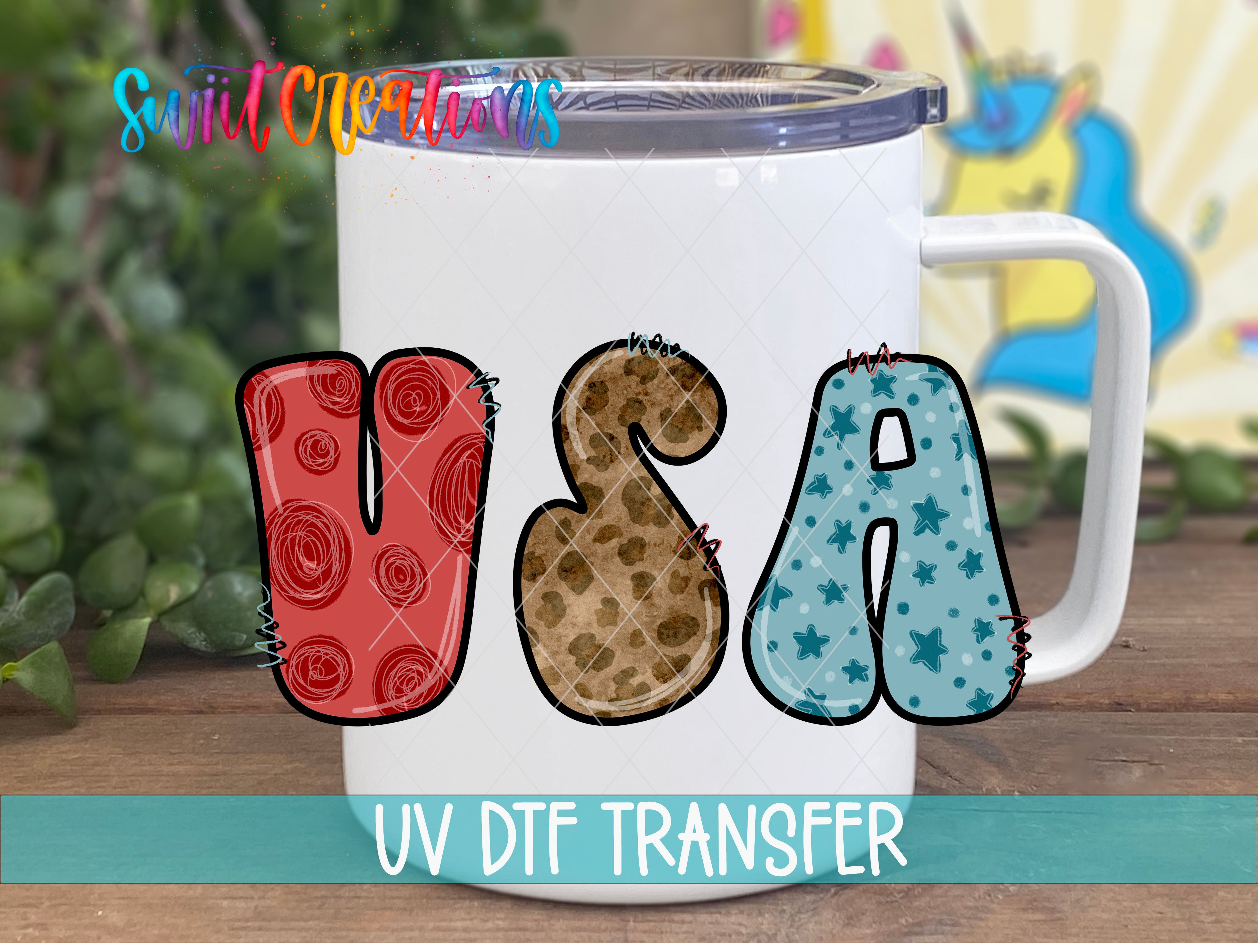 A white mug with the word "USA" printed on it, along with various colorful and abstract designs.