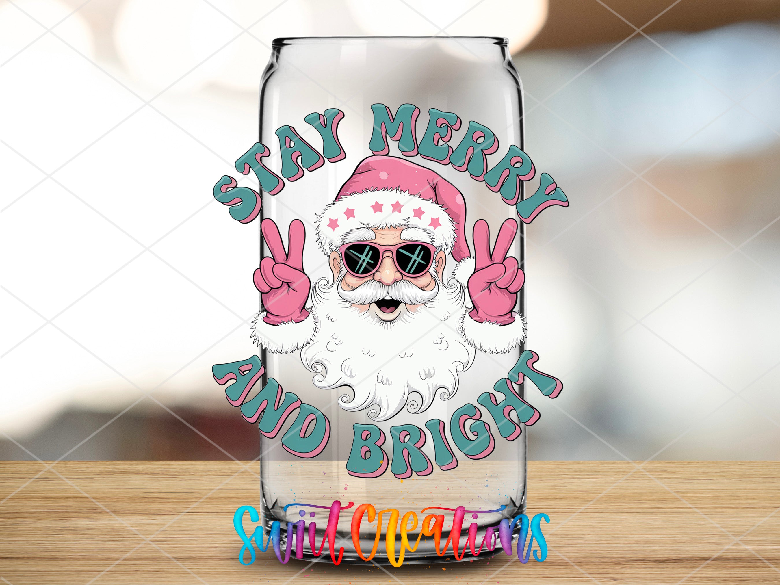 a glass with a santa clause on it sitting on a table