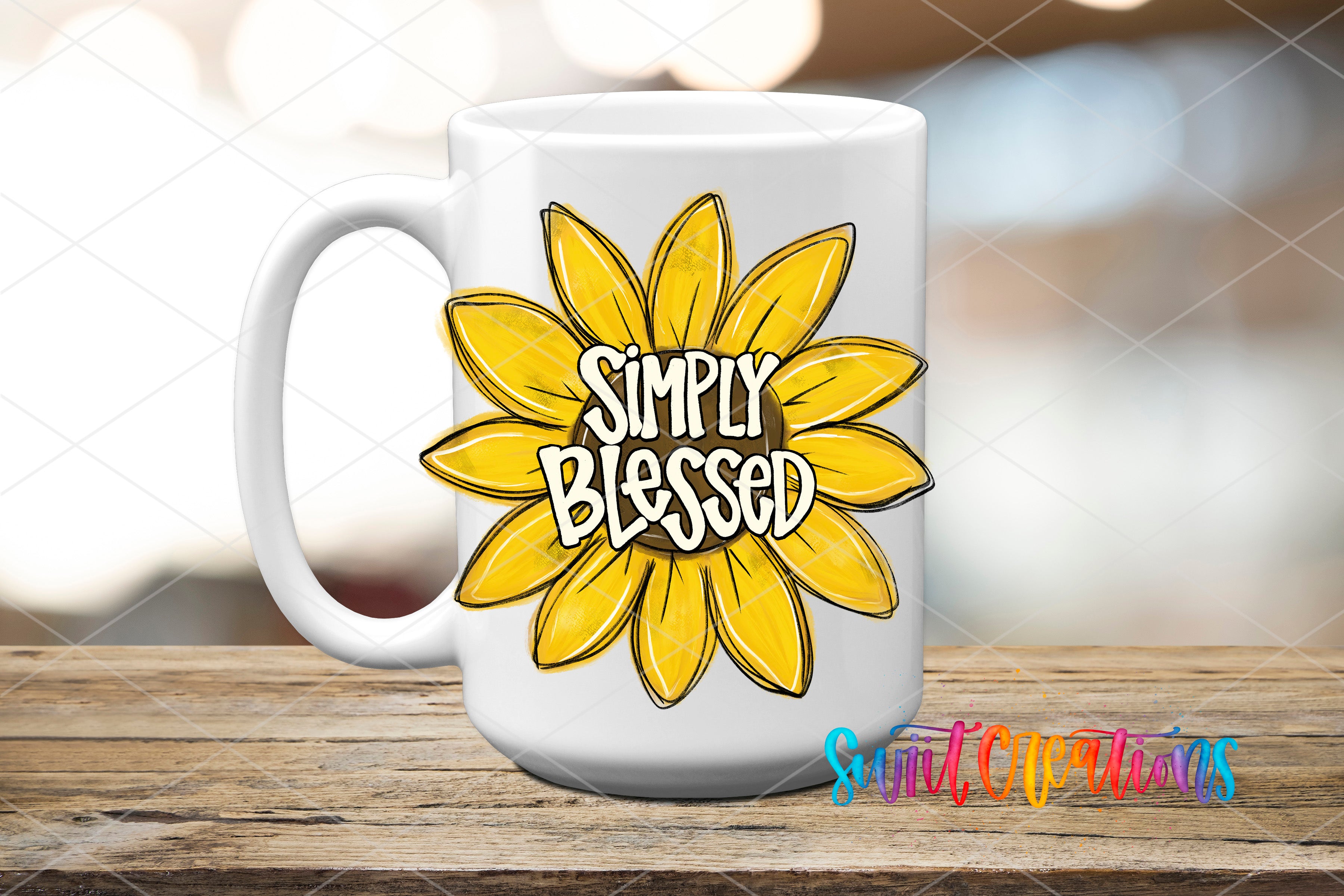 A white ceramic mug with a yellow flower design and the text "Simply Blessed" printed on it, placed on a wooden surface.
