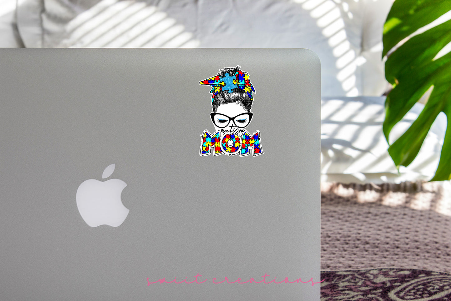 a laptop with a sticker of a woman with glasses