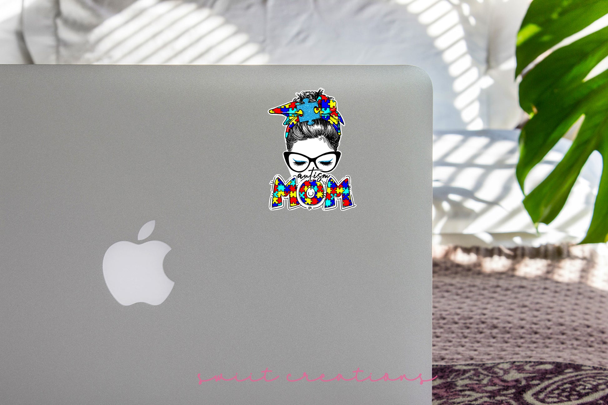 a laptop with a sticker of a woman with glasses