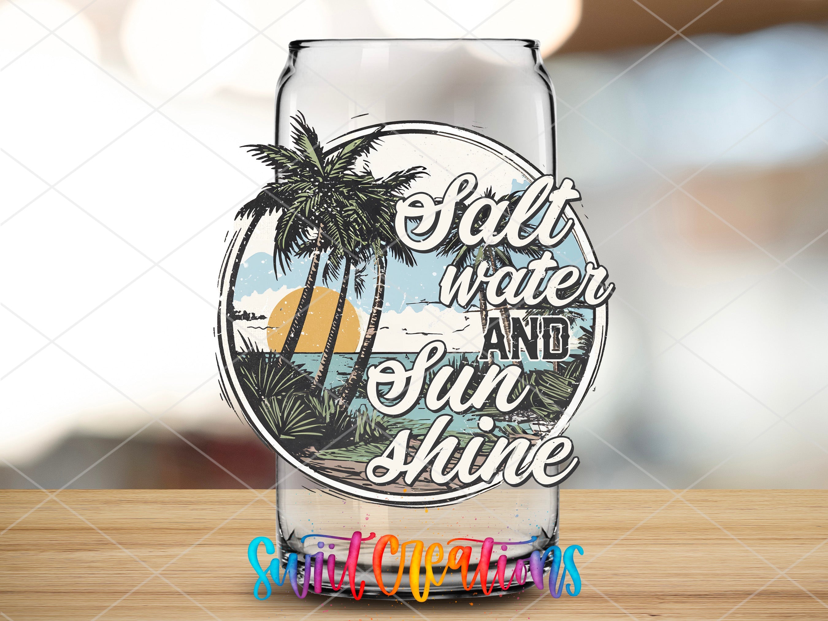 a glass with a tropical scene on it