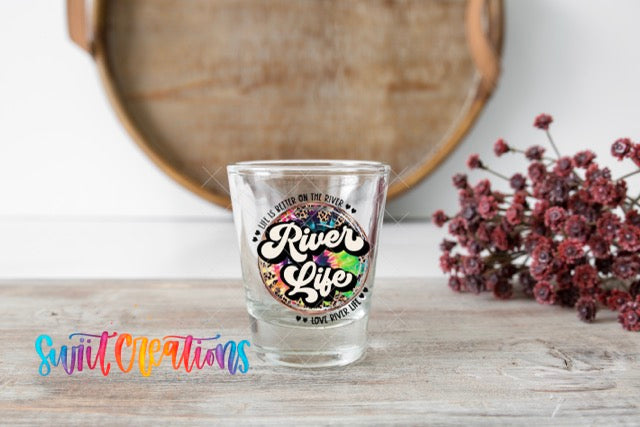 a shot glass sitting on top of a wooden table