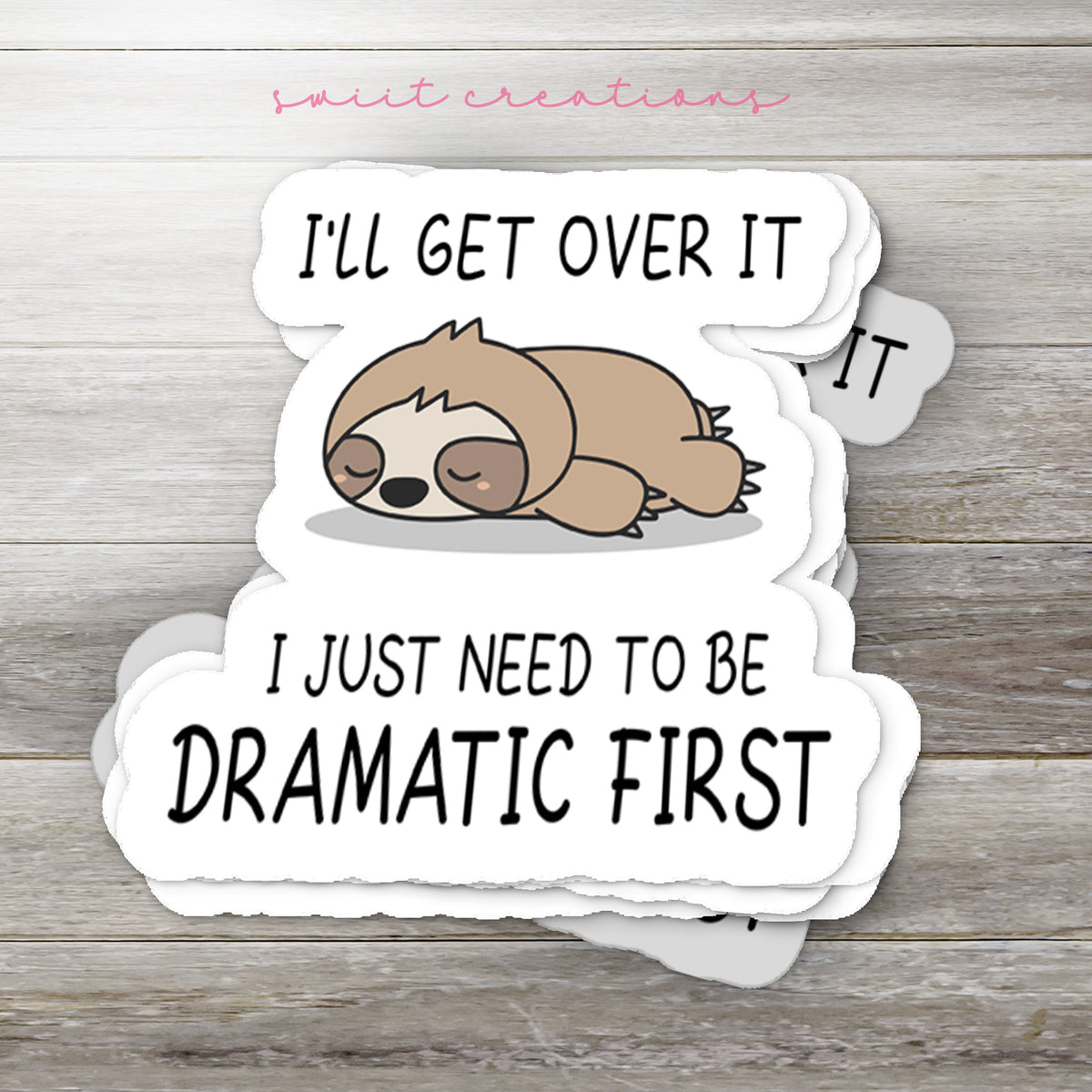 Stack of Dramatic Sloth glossy stickers on a gray wood table