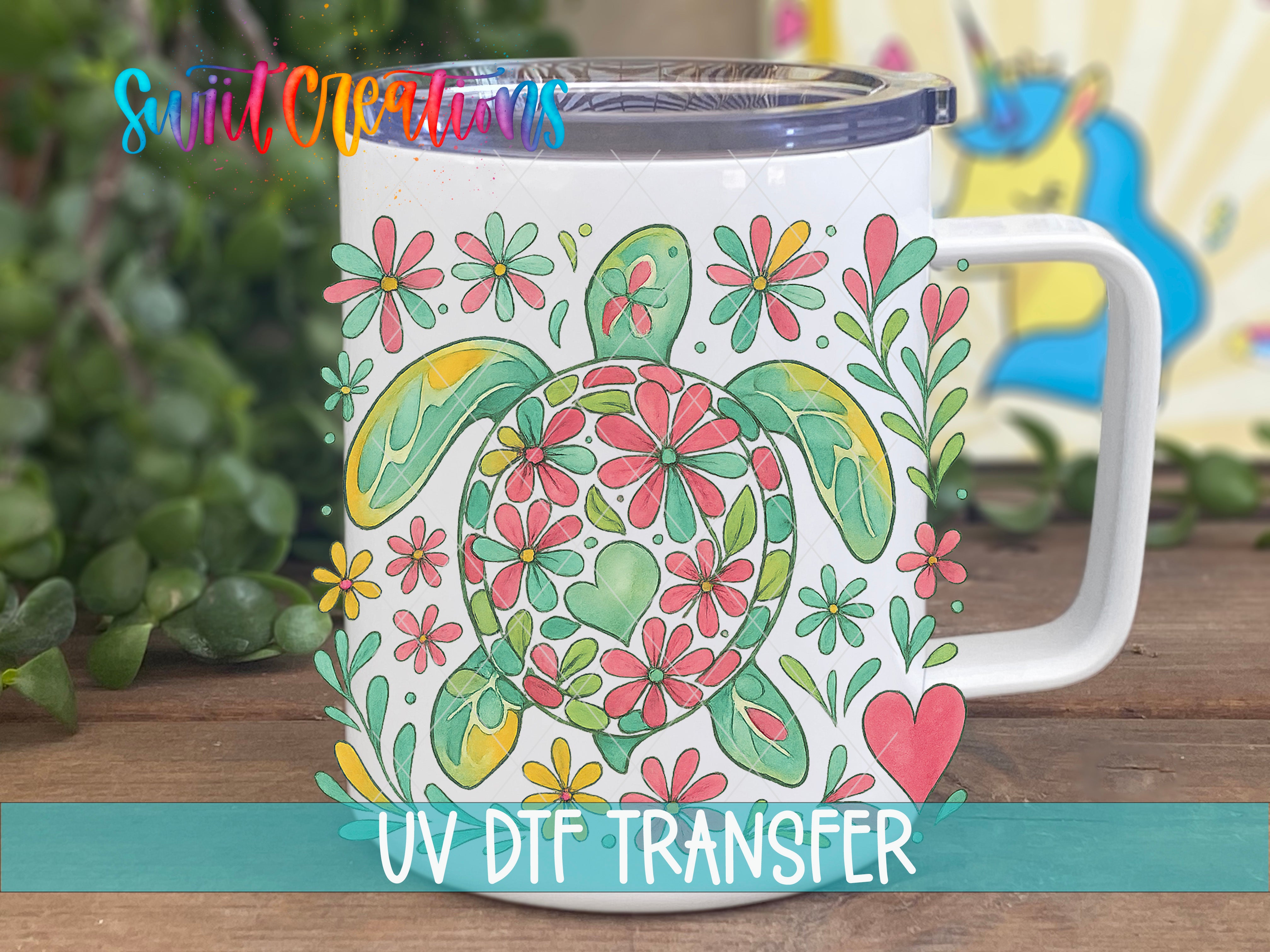 A white ceramic mug with a colorful turtle design and various flowers printed on it, placed on a wooden surface.