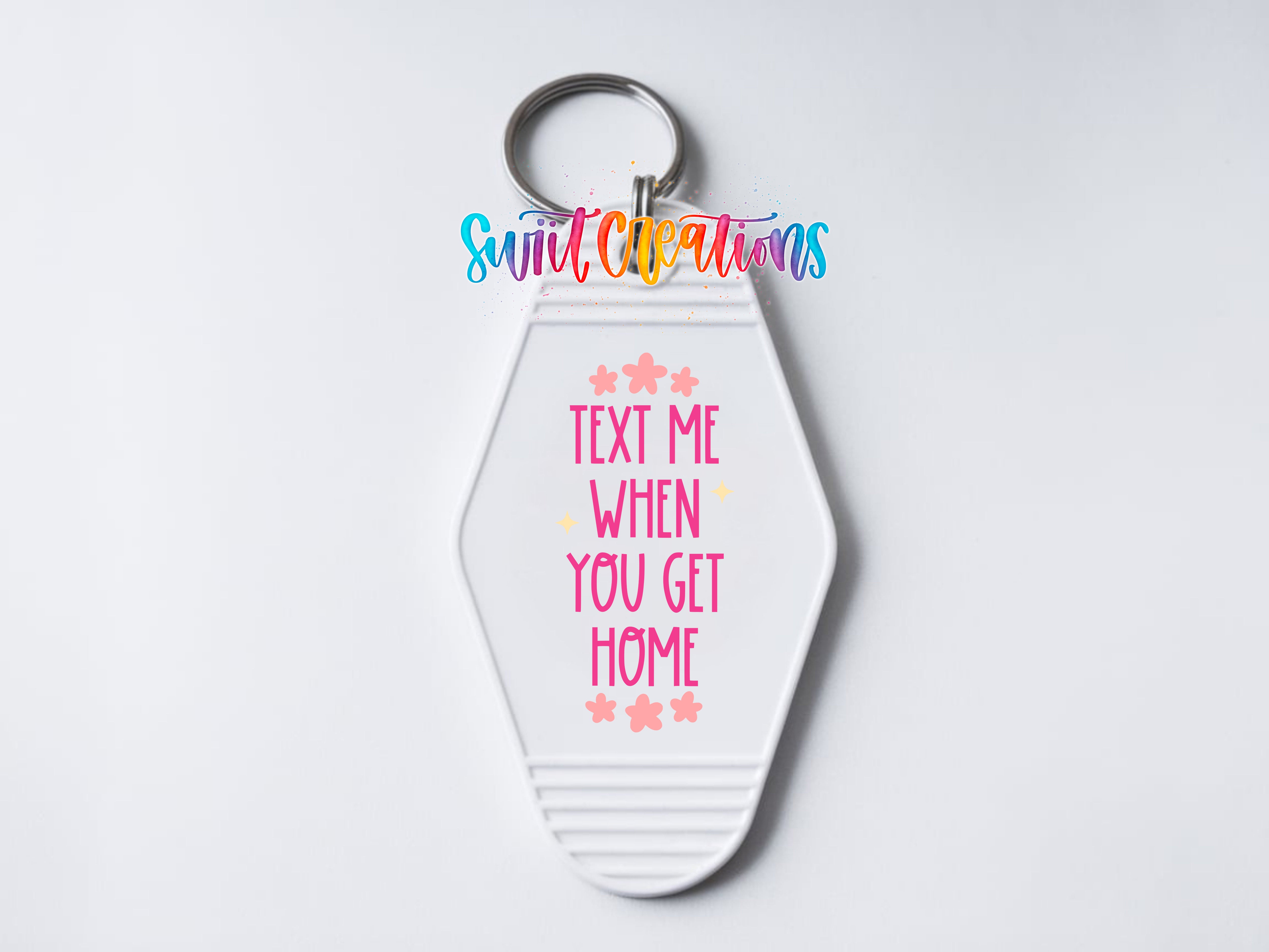 A keychain with a message that says "Text me when you get home" in a colorful, playful font.