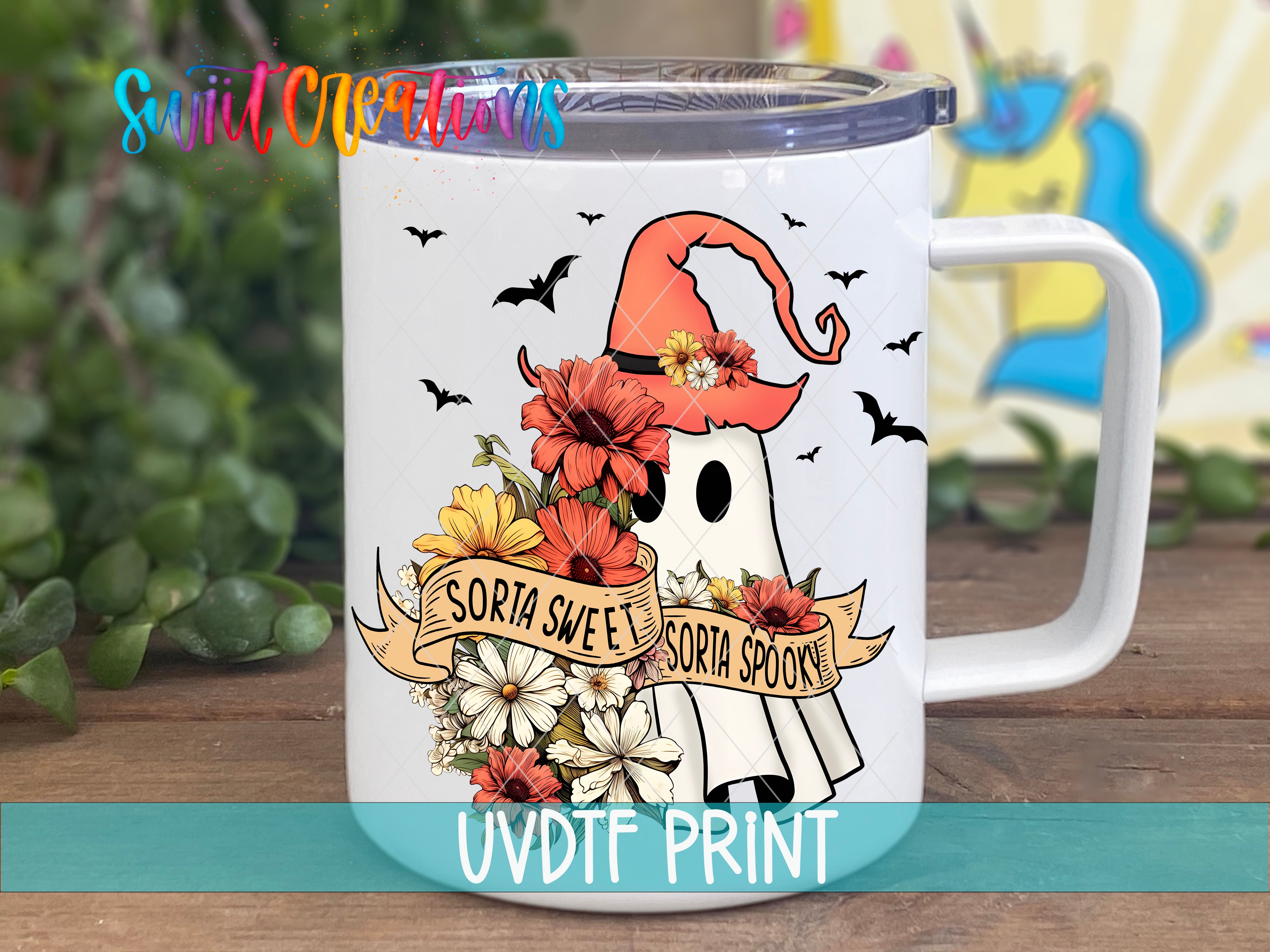 A white mug with a Halloween-themed design featuring a ghost, flowers, and a banner that says "SORIA SWEET SORIA SPOOK".