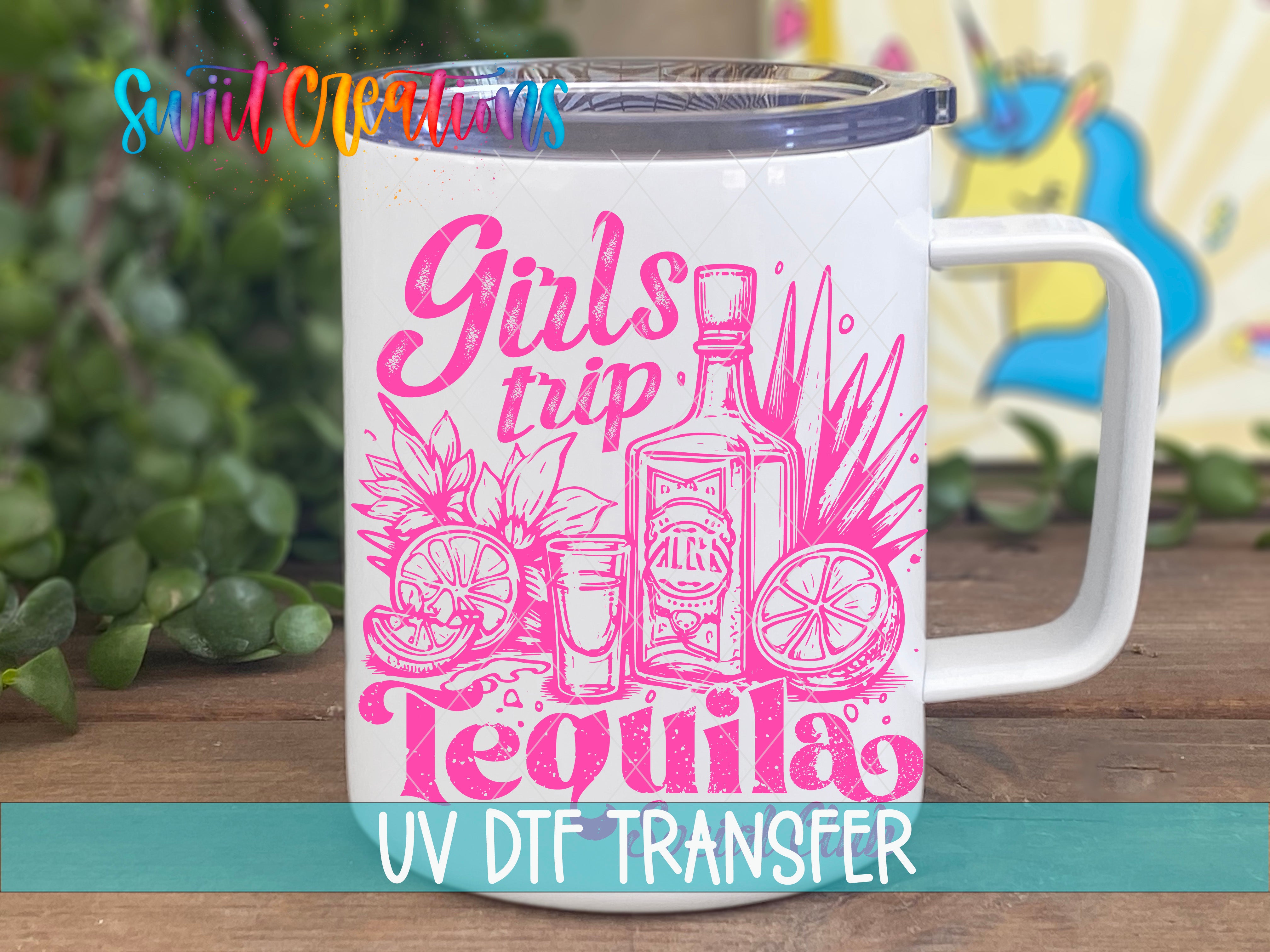 A white mug with a printed design featuring a bottle of tequila, a lime, and a tequila shot, along with the text "Girls trip Tequila" and "UV Dtf Transfer".