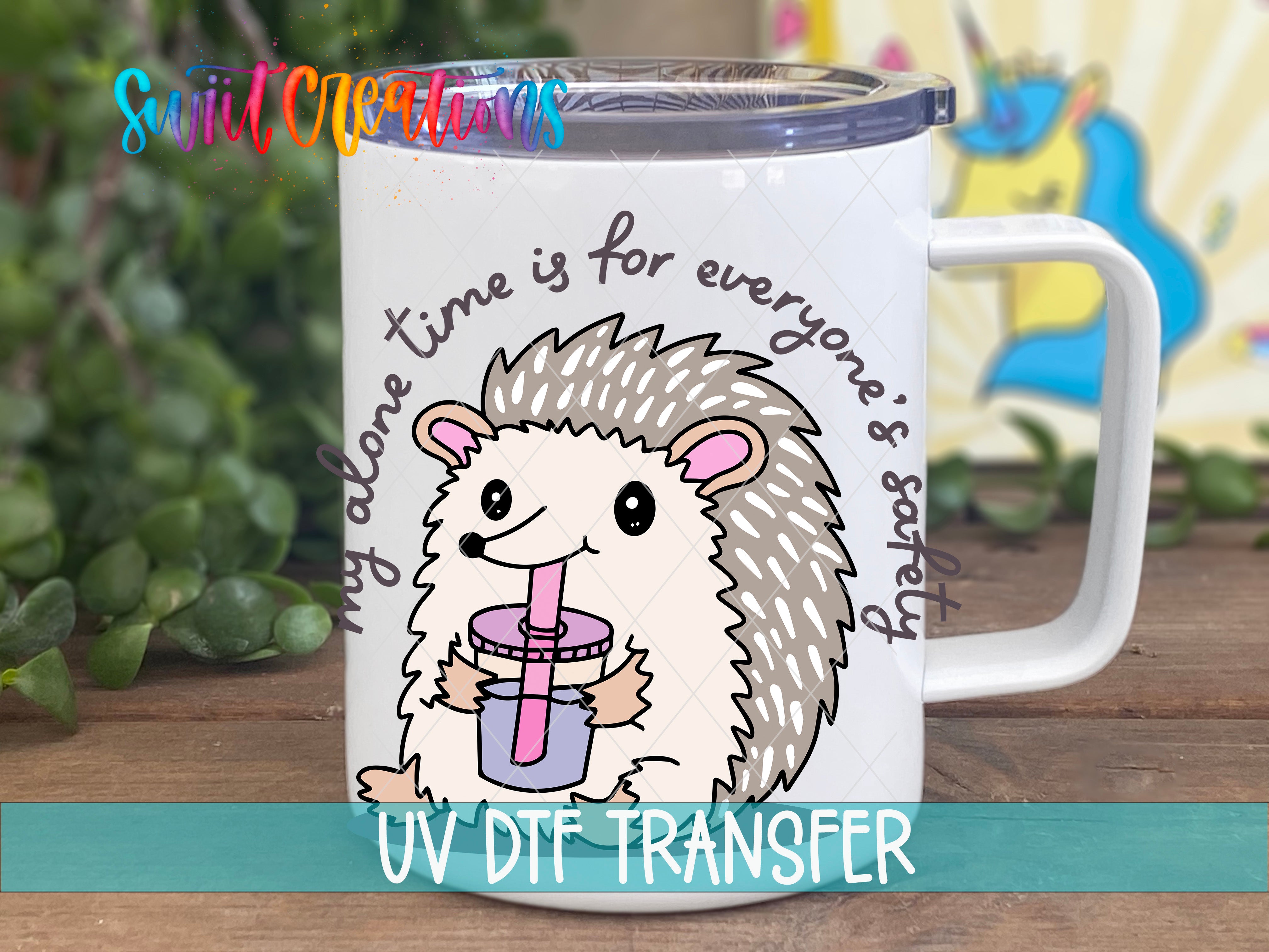 A mug with a cartoon hedgehog holding a drink, surrounded by text that says "My alone time is for everyone's safety".