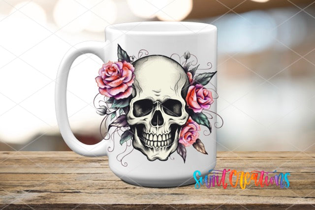 a coffee mug with a skull and roses on it