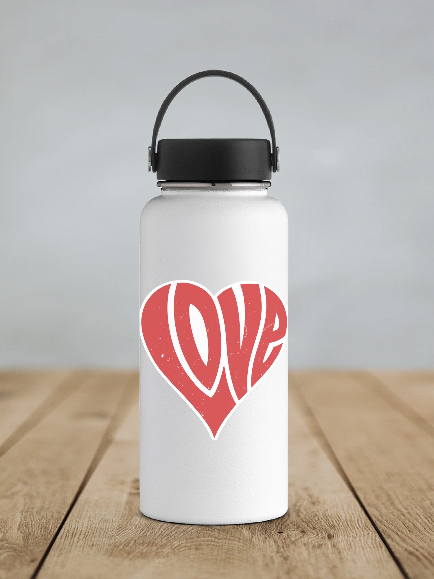 a white water bottle with a red heart on it