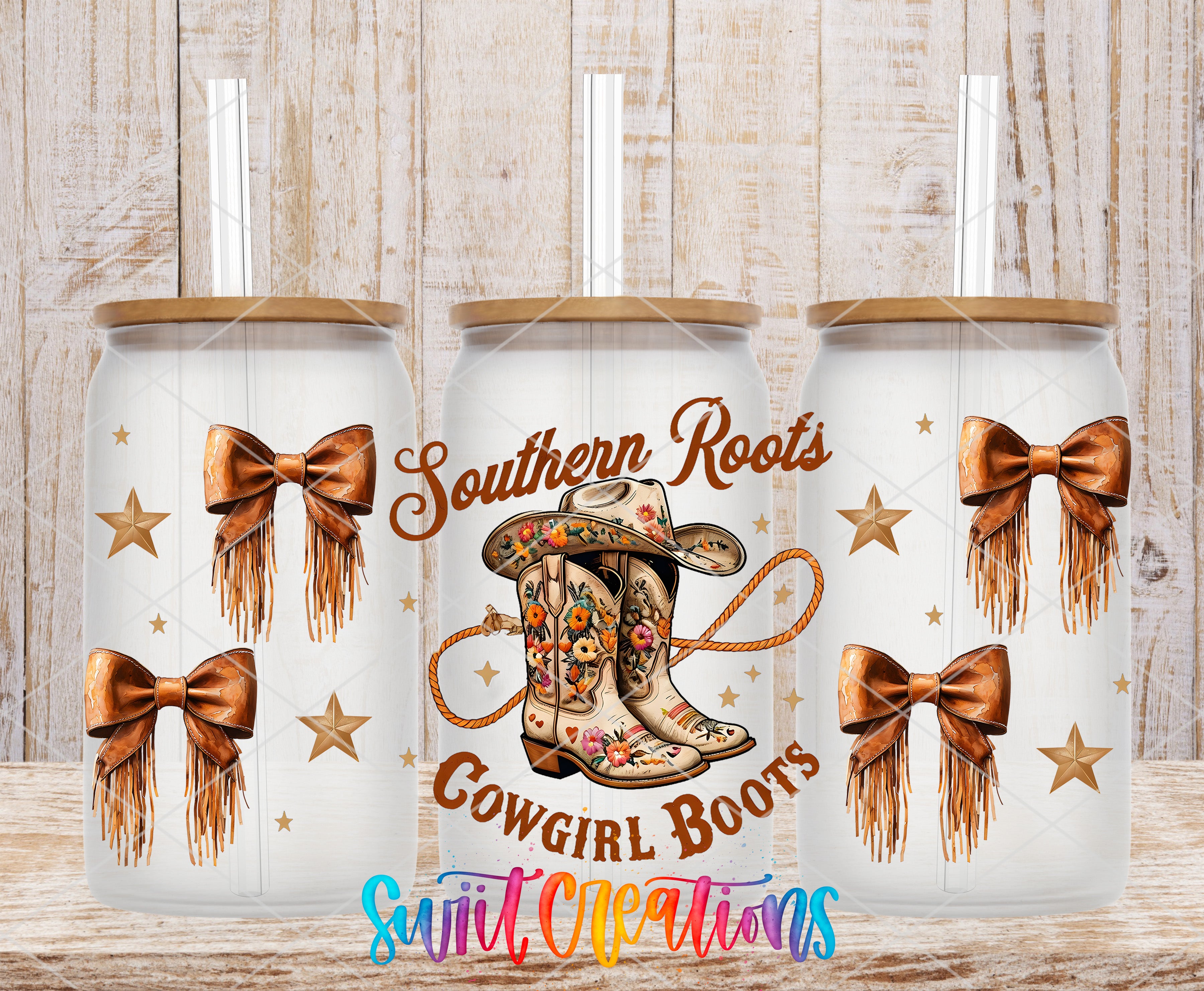 three white tumblers with gold bows and cowboy boots printed on them, set against a wooden background.
