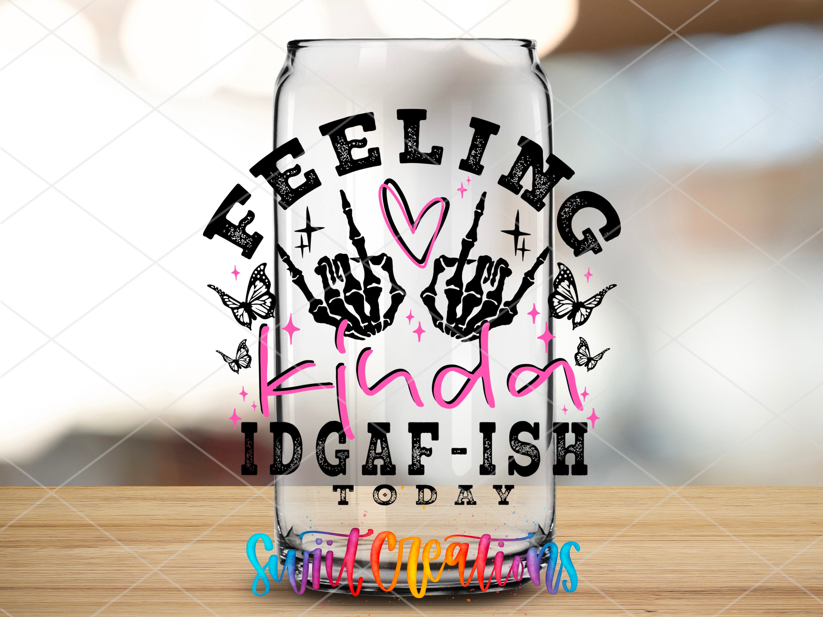 a glass with a saying on it sitting on a table