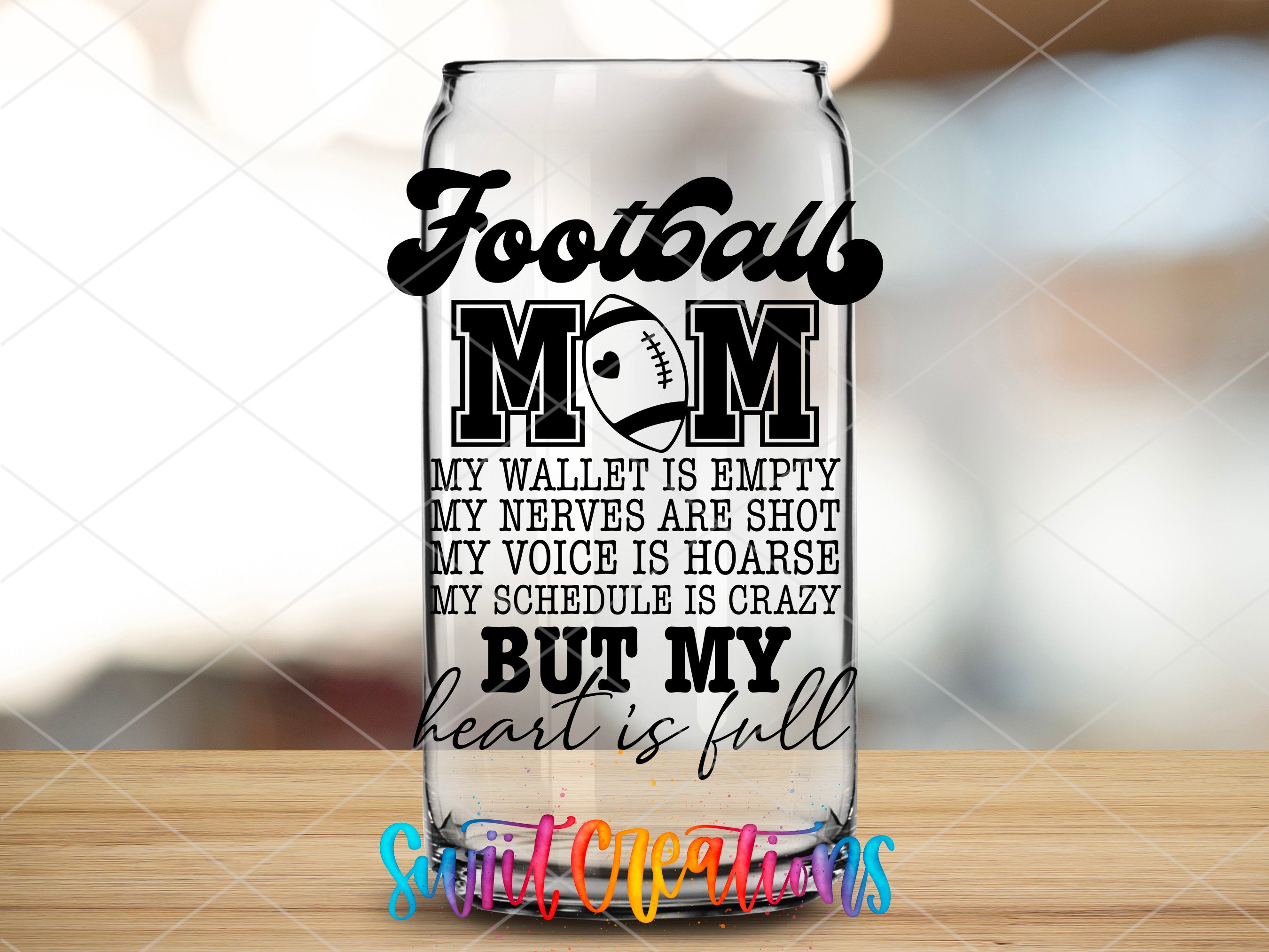 a glass with a football mom saying on it