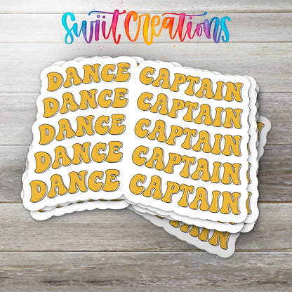 A stack of white stickers with the word "DANCE" written in a stylized font.