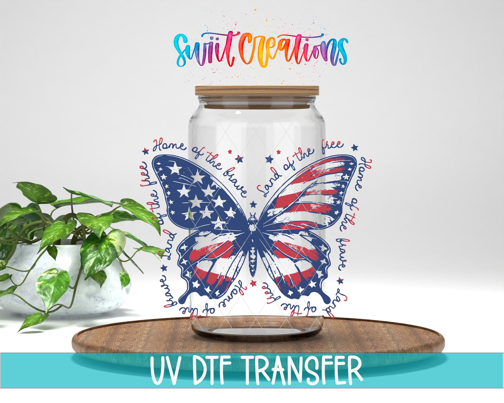 a clear glass jar with a butterfly design, surrounded by text that reads "Land of the free" and "Land of the brave". The jar is placed on a wooden tray, and there is a potted plant in the background.