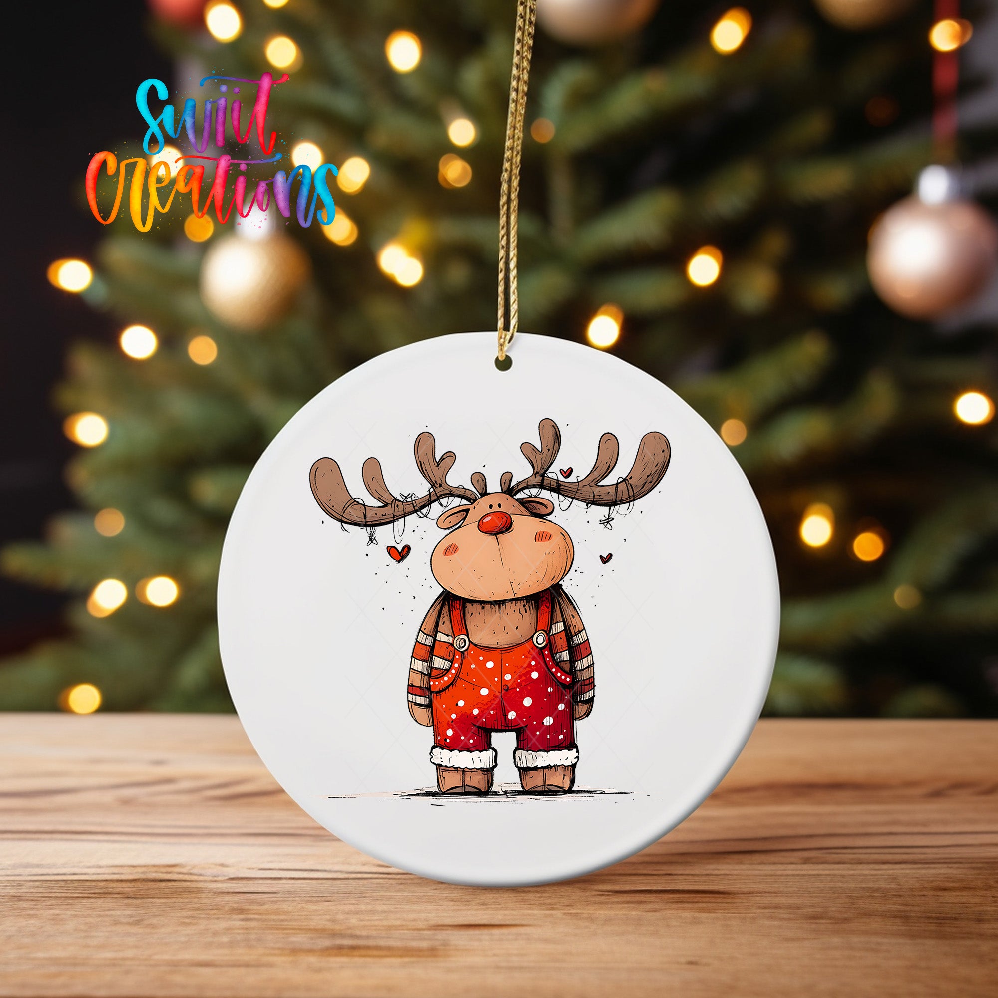 A white ornament featuring a cartoon reindeer with antlers and a red outfit, hanging on a string.