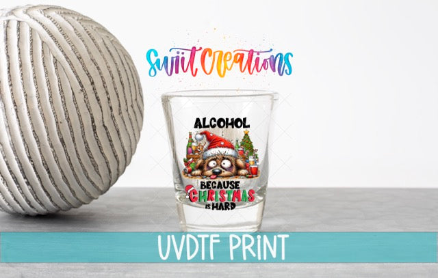 a glass of alcohol next to a ball of yarn