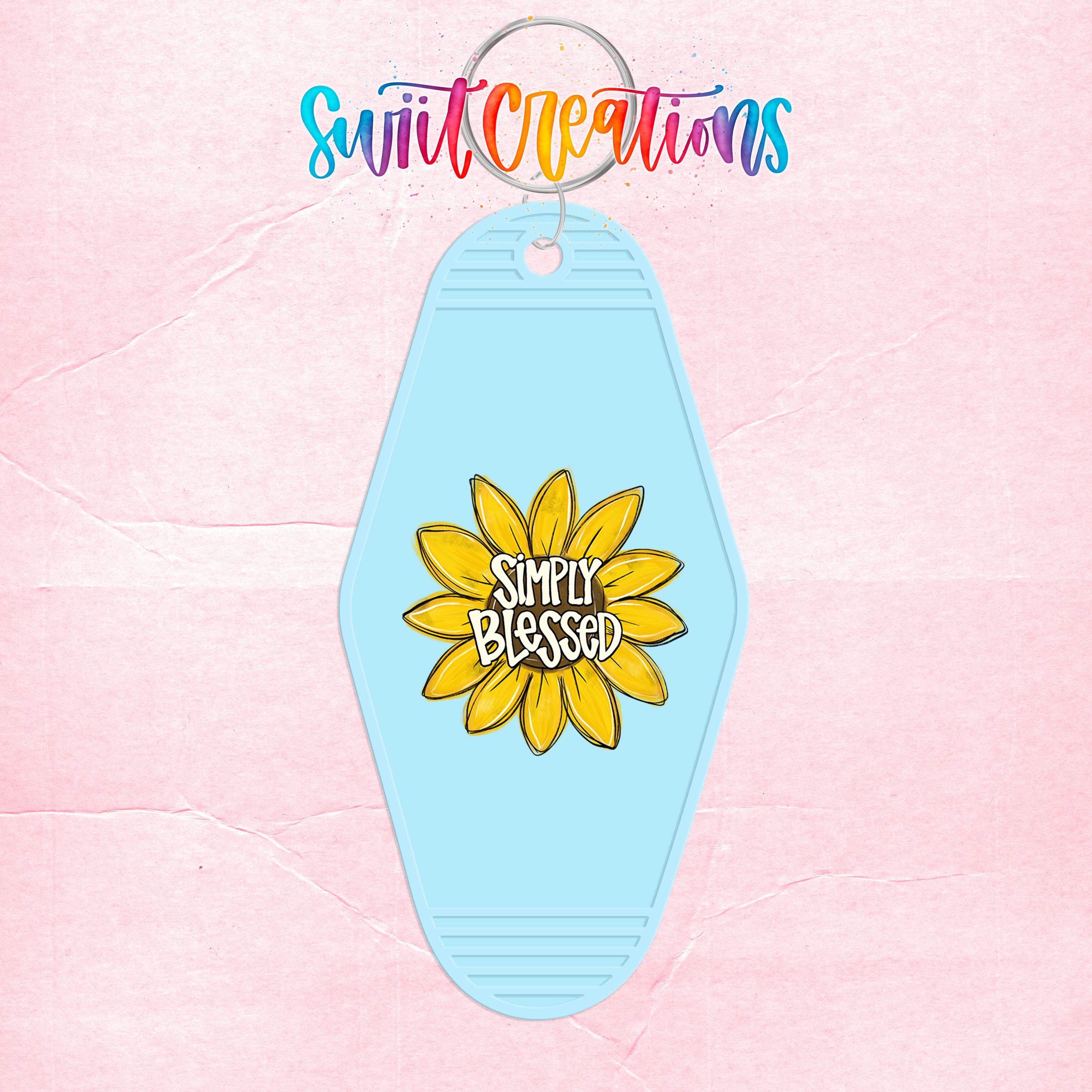A keychain with a blue flower design and the text "Simply Blessed" printed on it.
