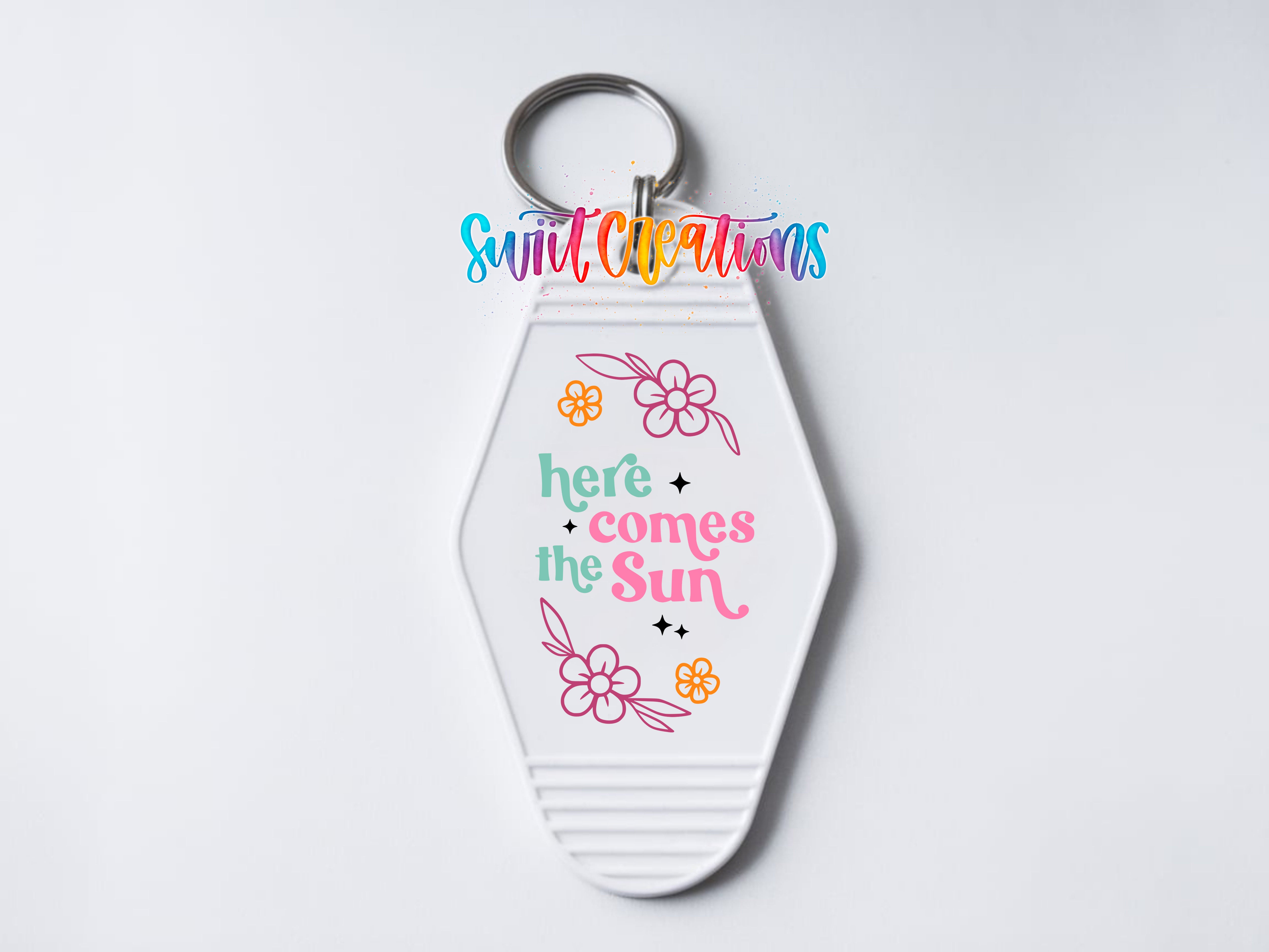 A keychain with a decorative design and text on it.
