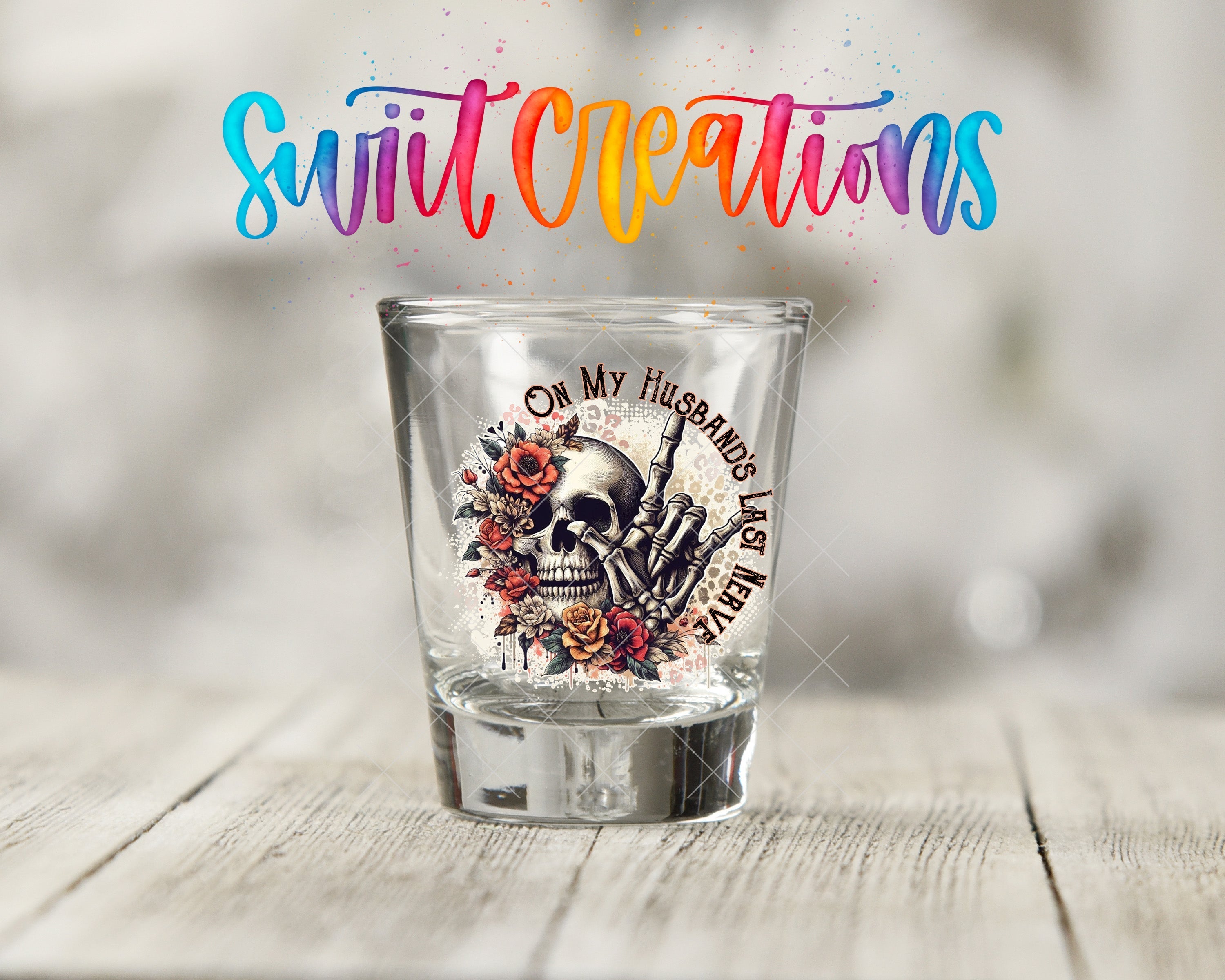a shot glass sitting on top of a wooden table