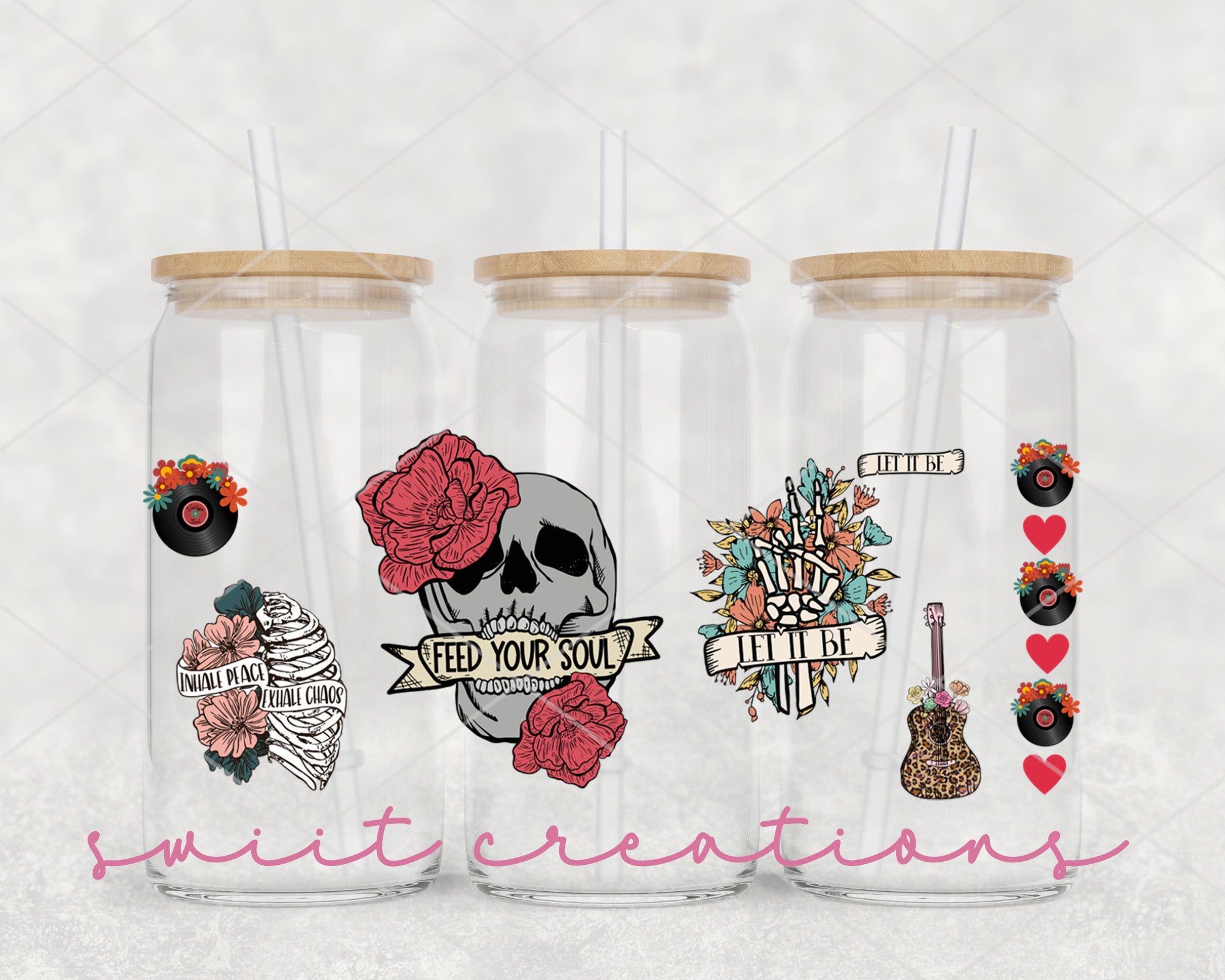three clear tumblers with stickers on them