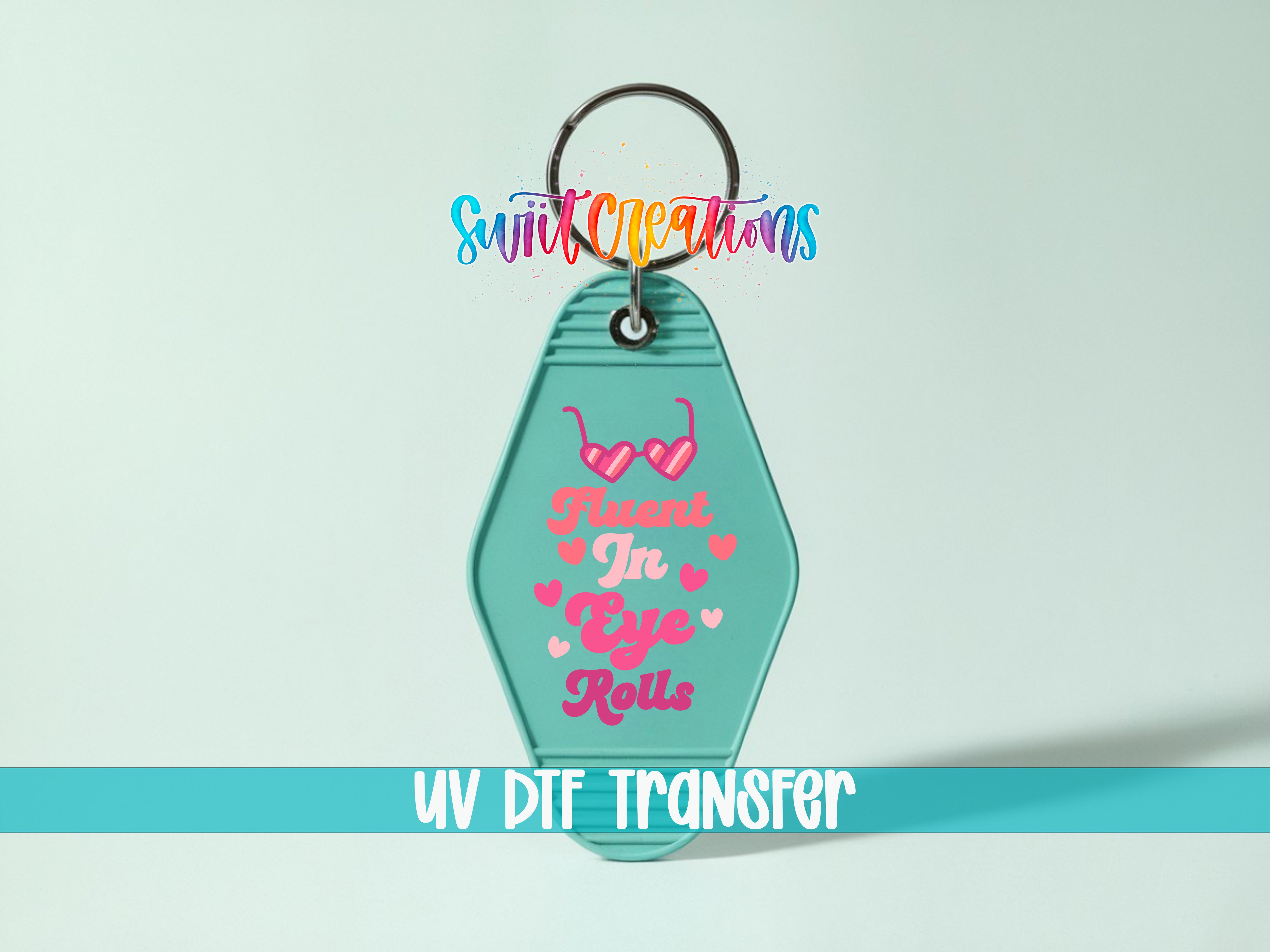 A keychain with a colorful design and text on it, along with a UV dye transfer label.