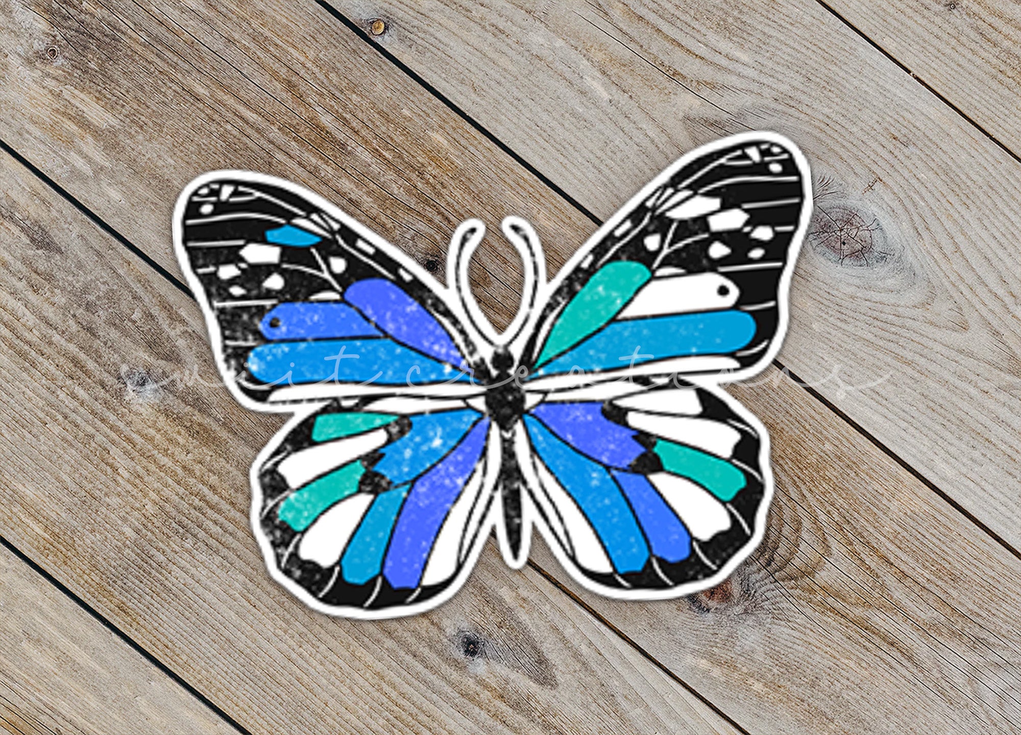 a sticker of a butterfly on a wooden floor