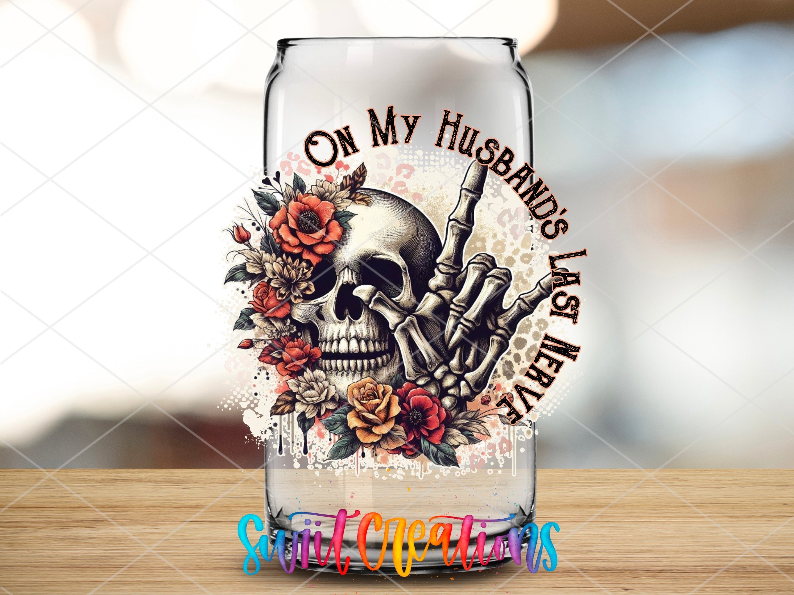 a glass with a skull and flowers on it