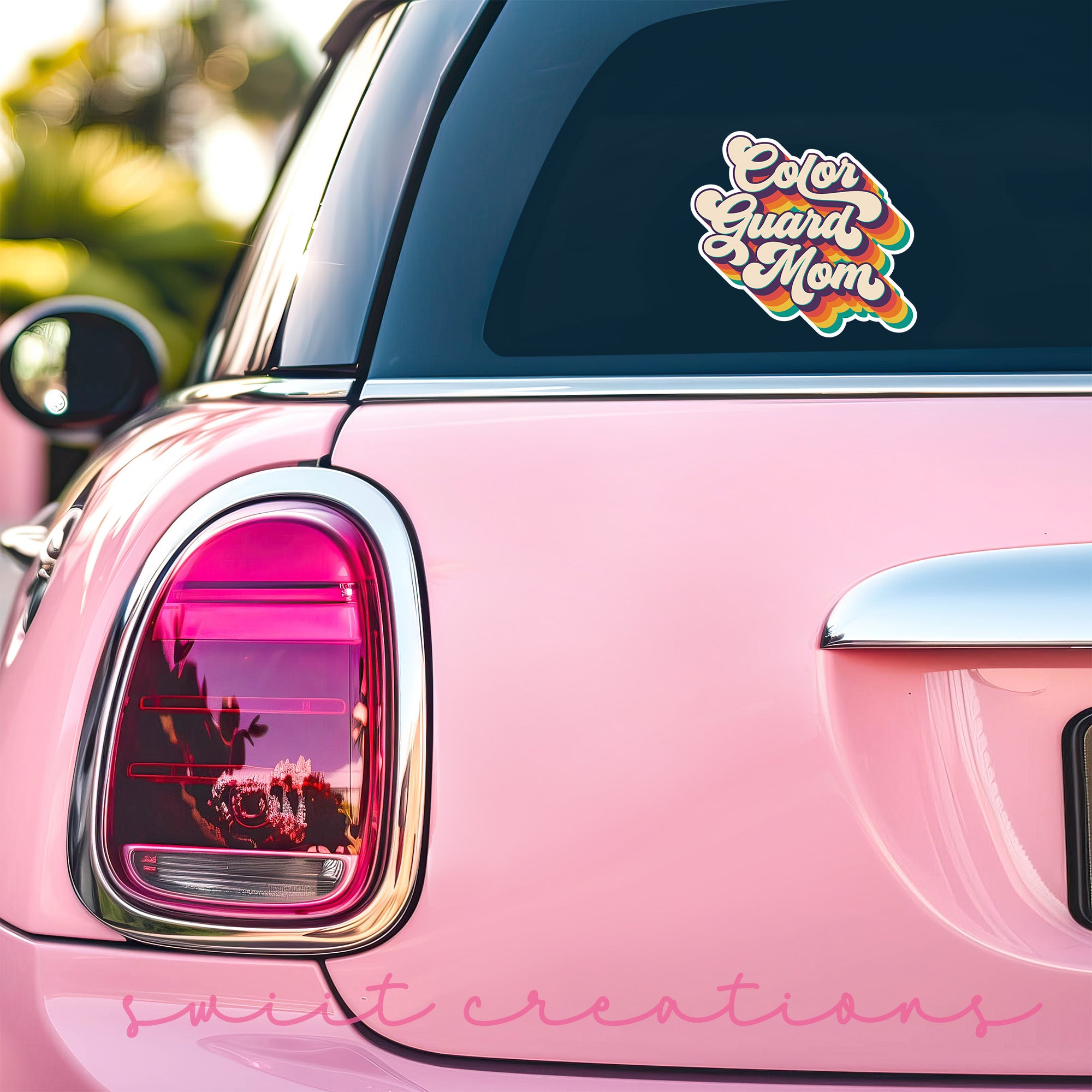 a pink car with a sticker on it