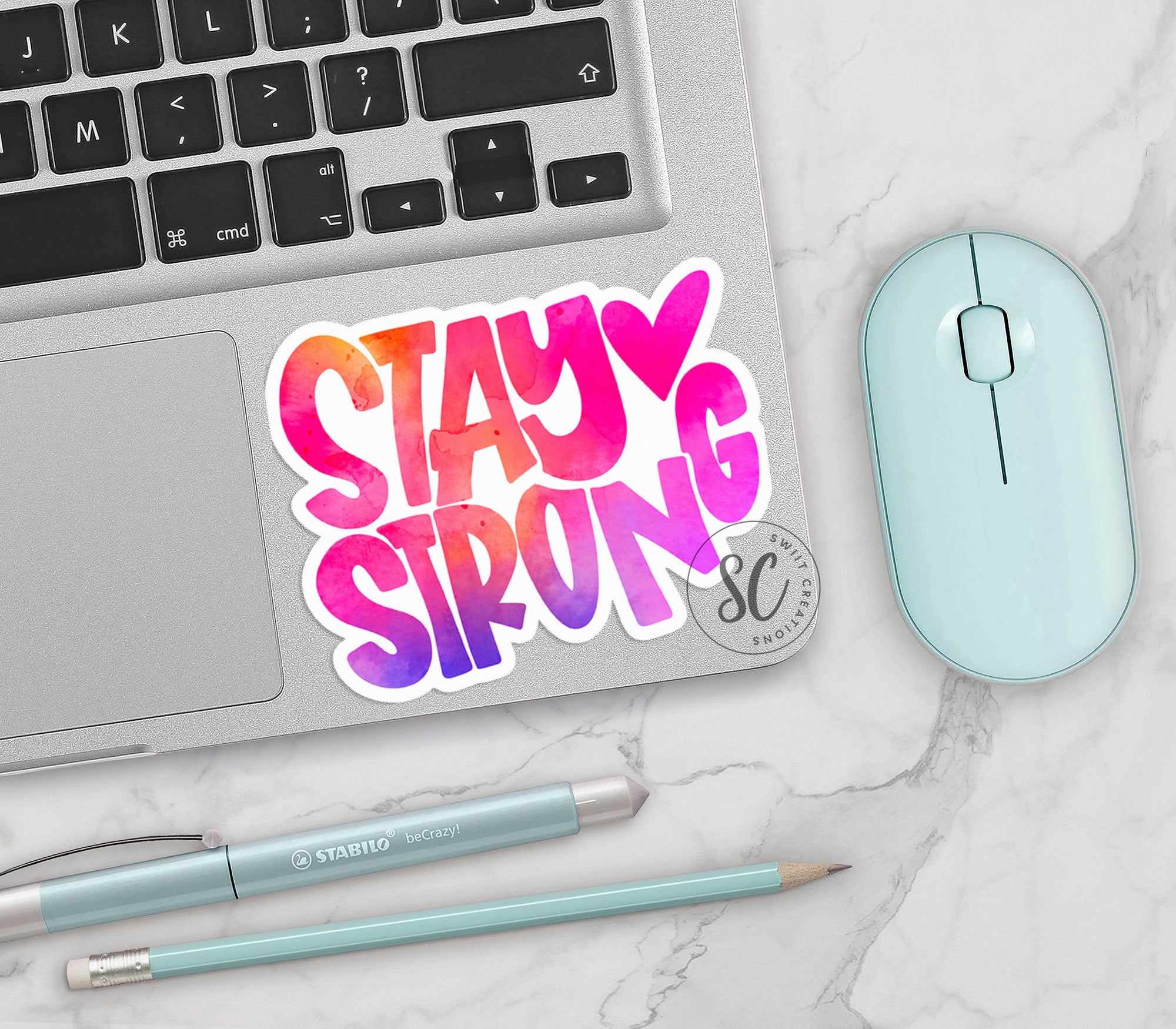 a laptop with a sticker that says stay strong