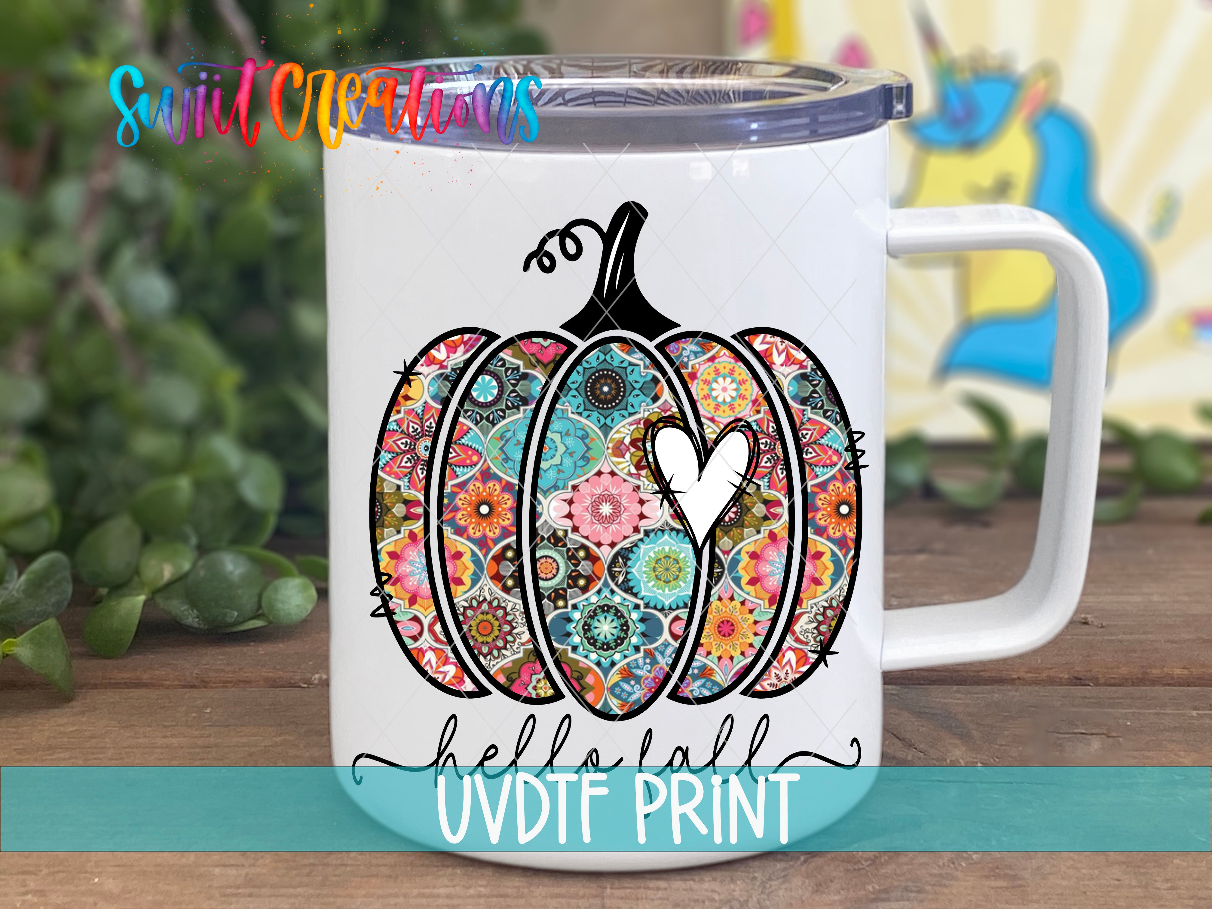 a white coffee mug with a colorful pumpkin on it
