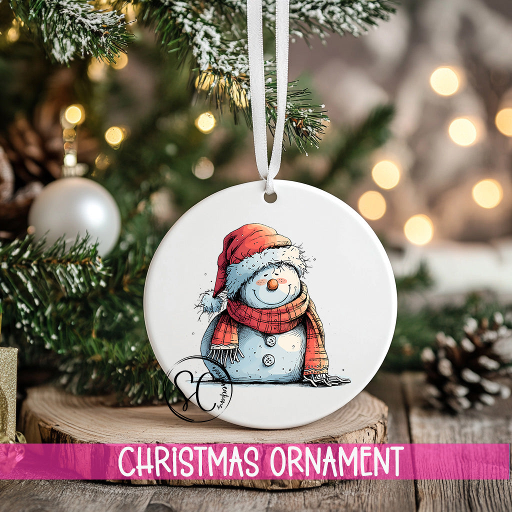 a snowman ornament hanging from a christmas tree