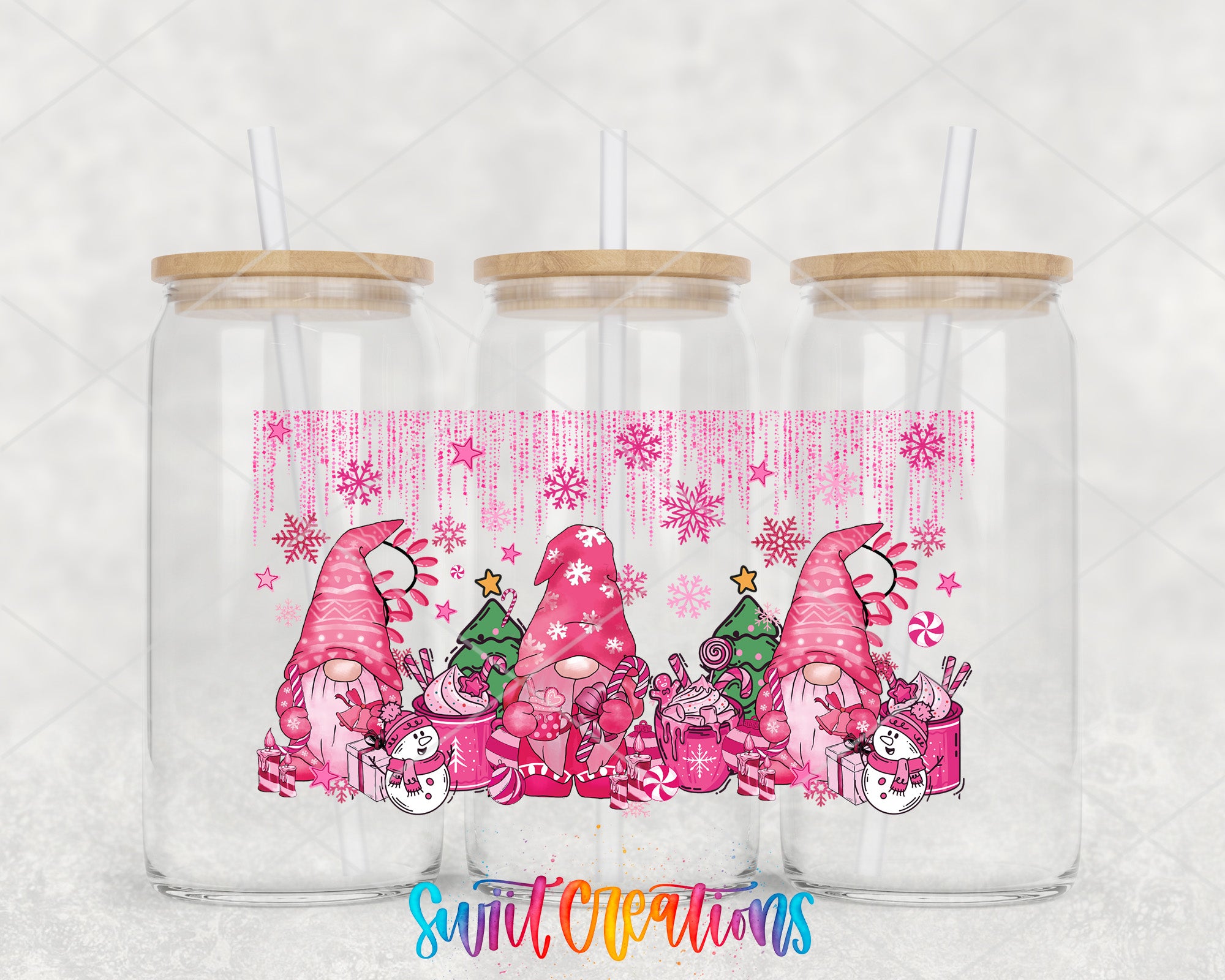 A trio of clear glass tumblers with wooden lids, each adorned with a festive pink and white Christmas-themed design featuring gnomes, snowflakes, and Christmas trees.